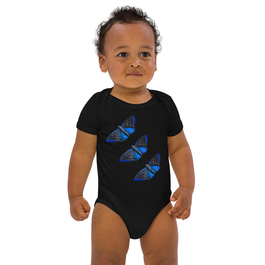 Baby with a black bodysuit with a picture of three butterfly's