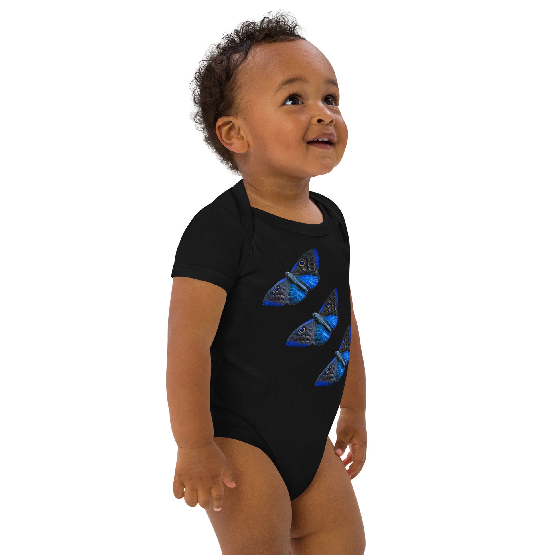 Baby with a black bodysuit with a picture of three butterfly's