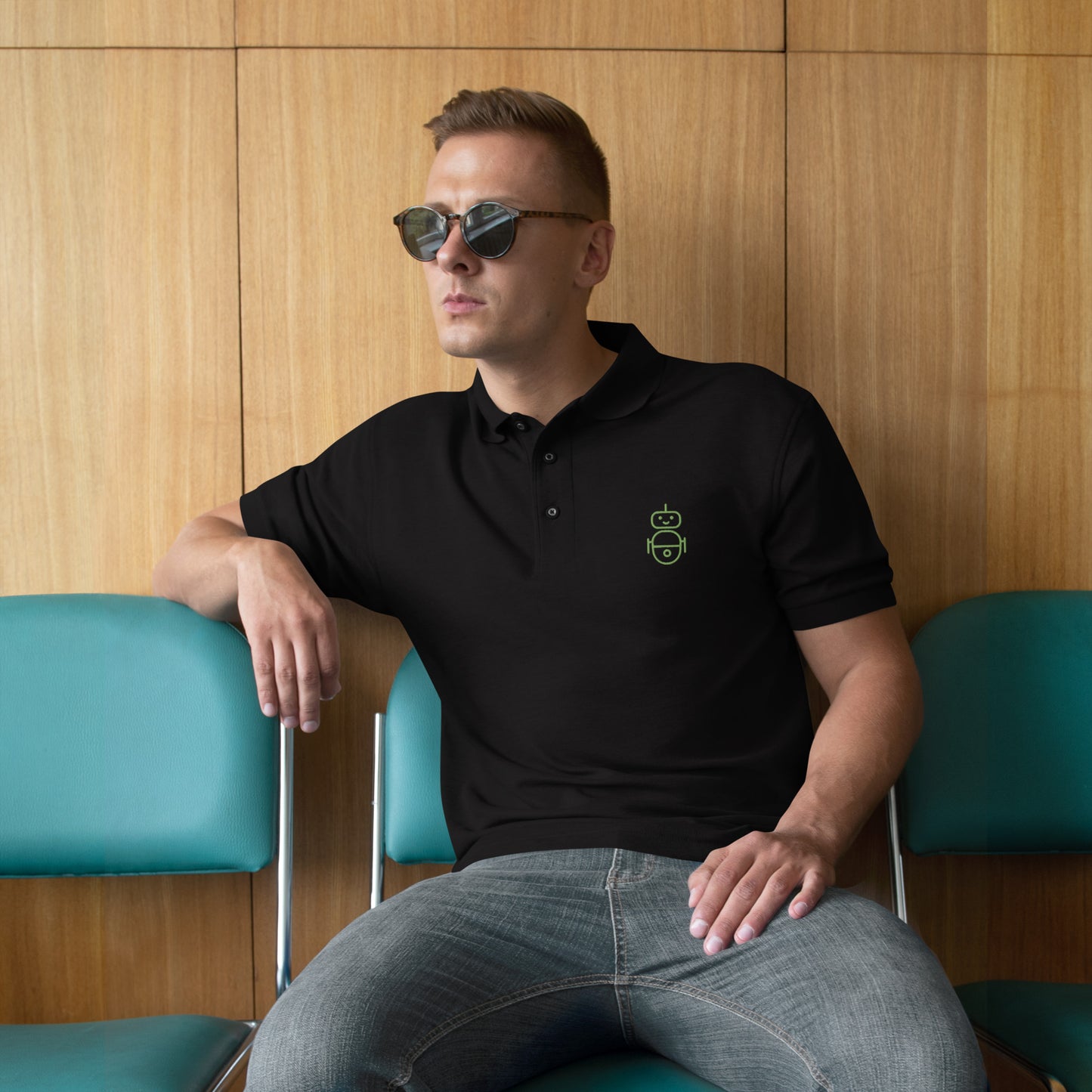 Men with black polo and in green it Android logo