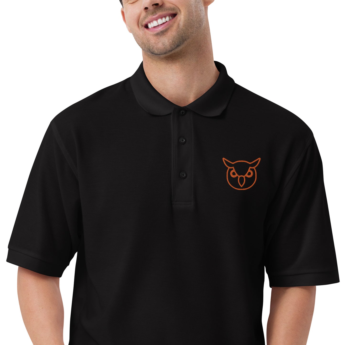 Men with black poloshirt with on front a owl in brown embroidered