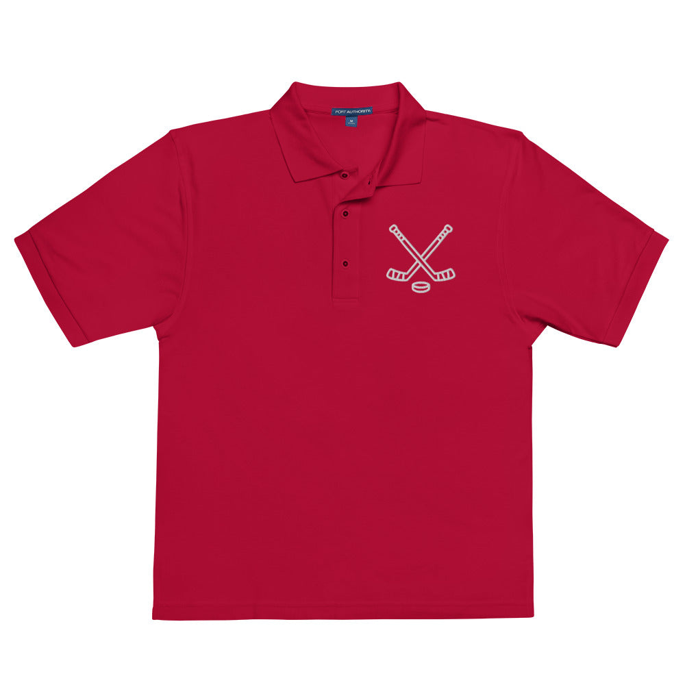 Red poloshirt with print of hockeysticks and puk
