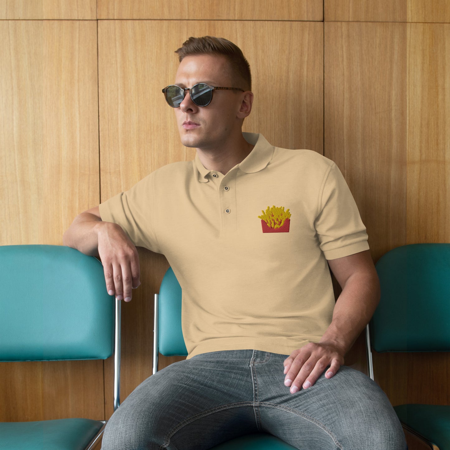 Man with stone polo with picture of fries