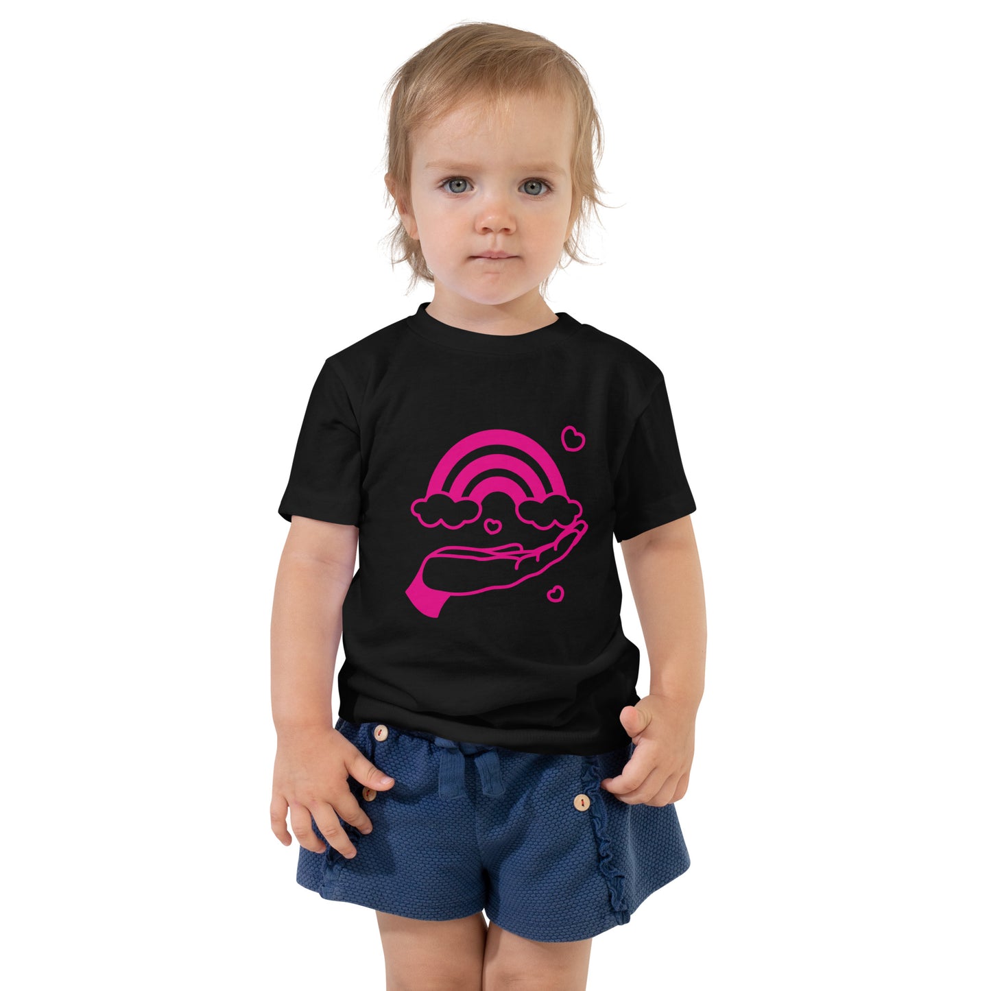 toddler with black t-shirt with print of pink hand holding a pink rainbow