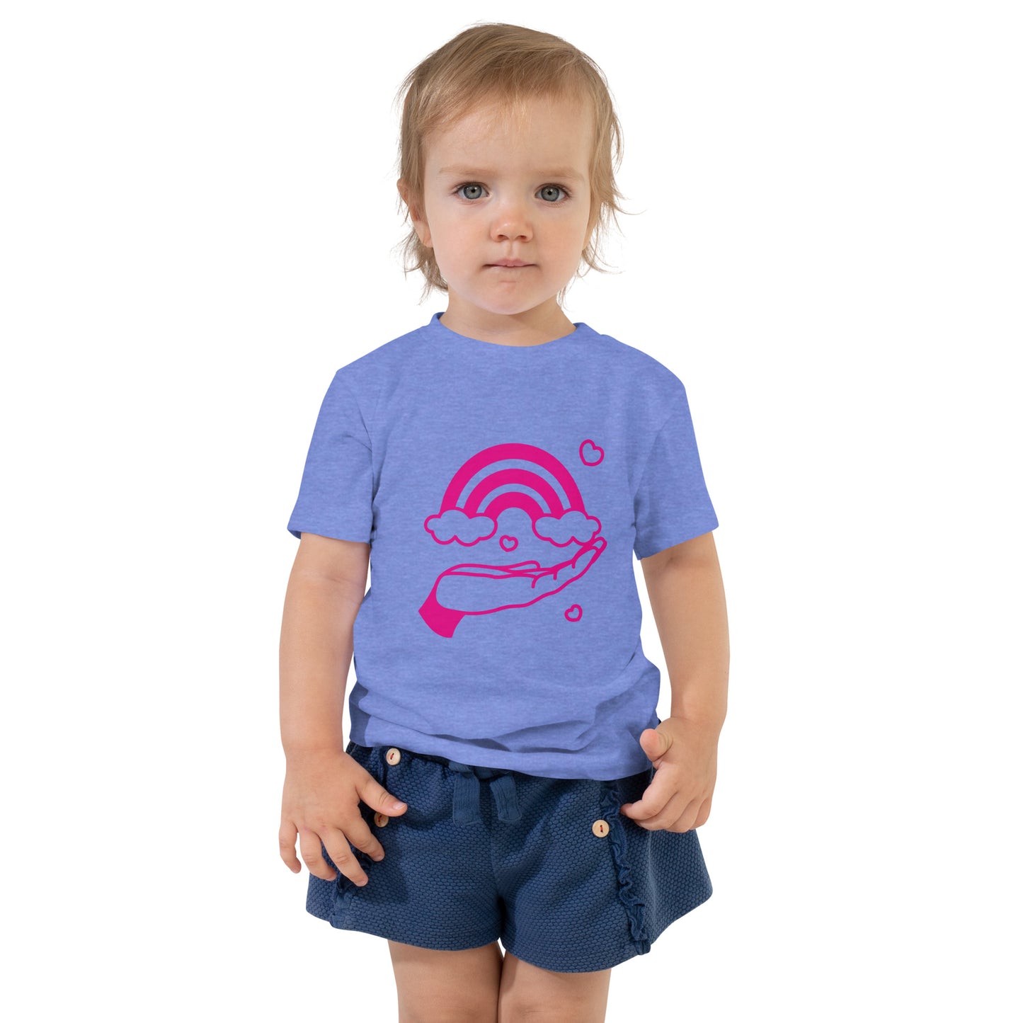 toddler with columbia blue t-shirt with print of pink hand holding a pink rainbow