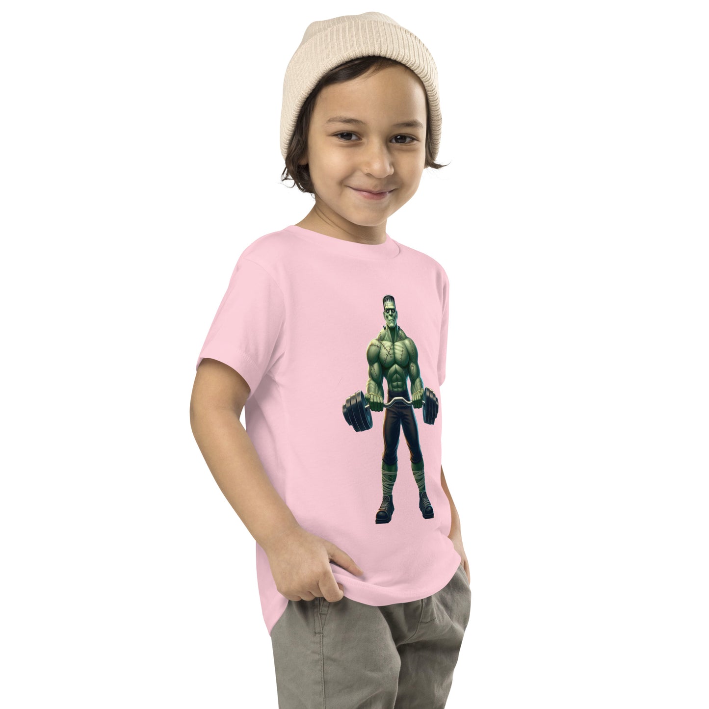 Toddler with pink T-shirt with a print of a bodybuilder