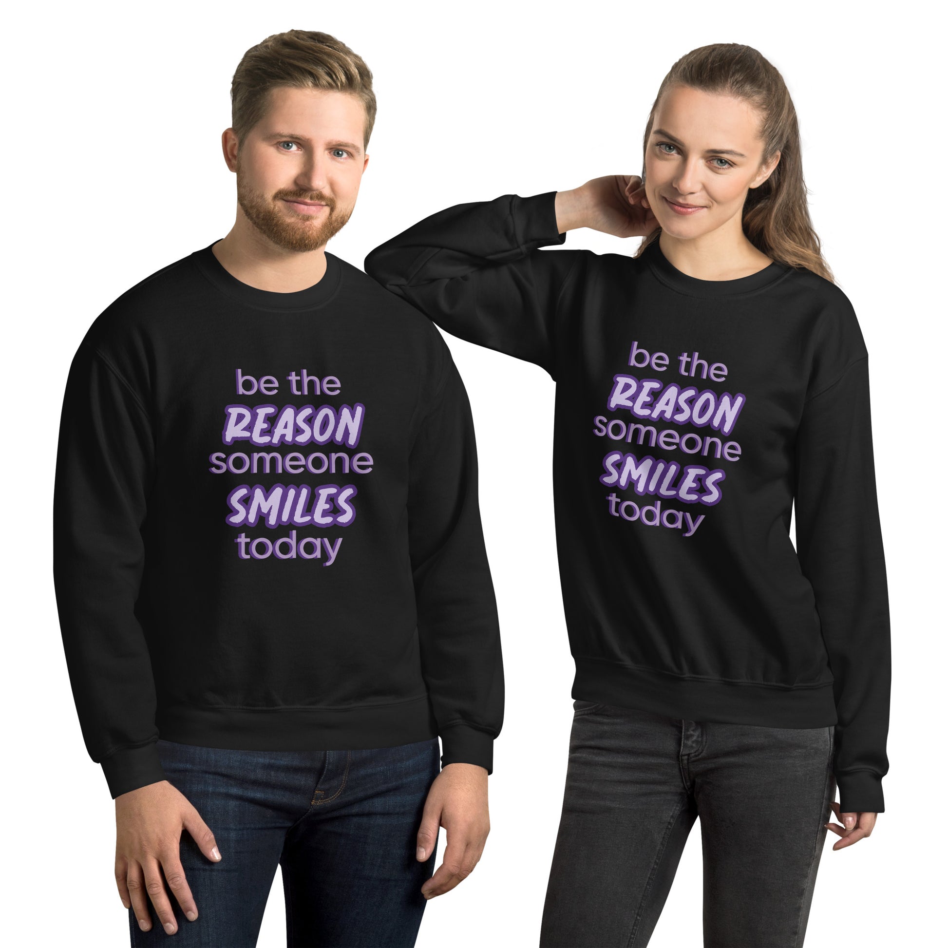 Men and women with black sweater and the quote "be the reason someone smiles today" in purple on it. 