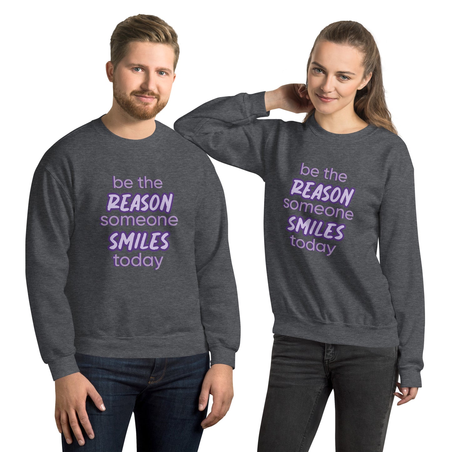 Men and women with dark grey sweater and the quote "be the reason someone smiles today" in purple on it. 