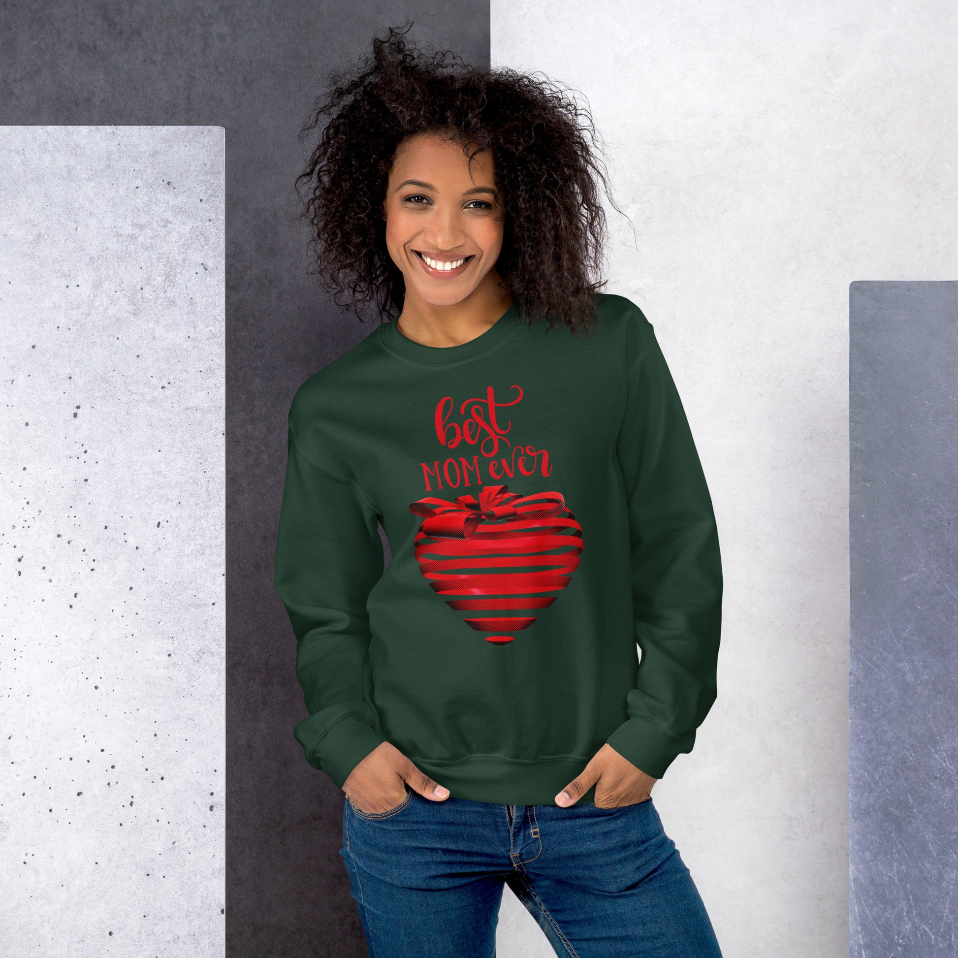 Women with forest green sweater with red text best MOM Ever and red heart