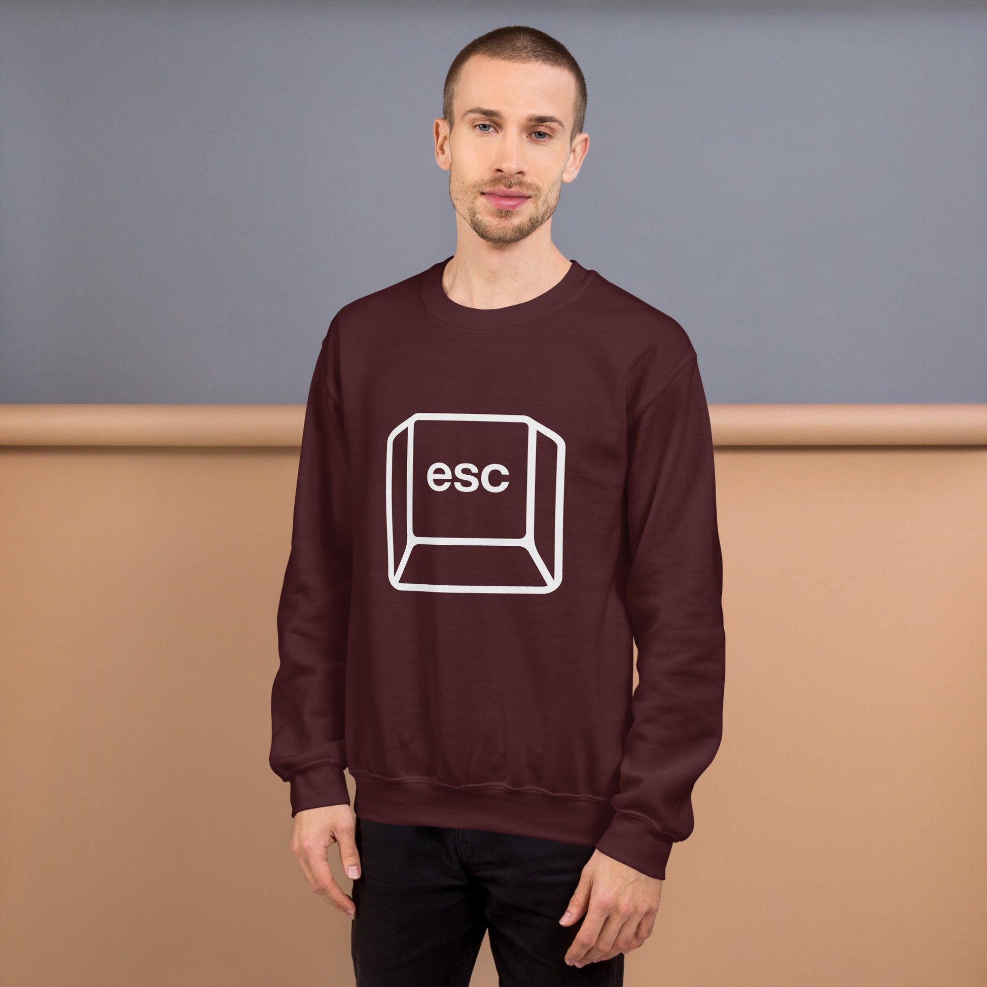 Man with maroon sweatshirt with picture of esc key