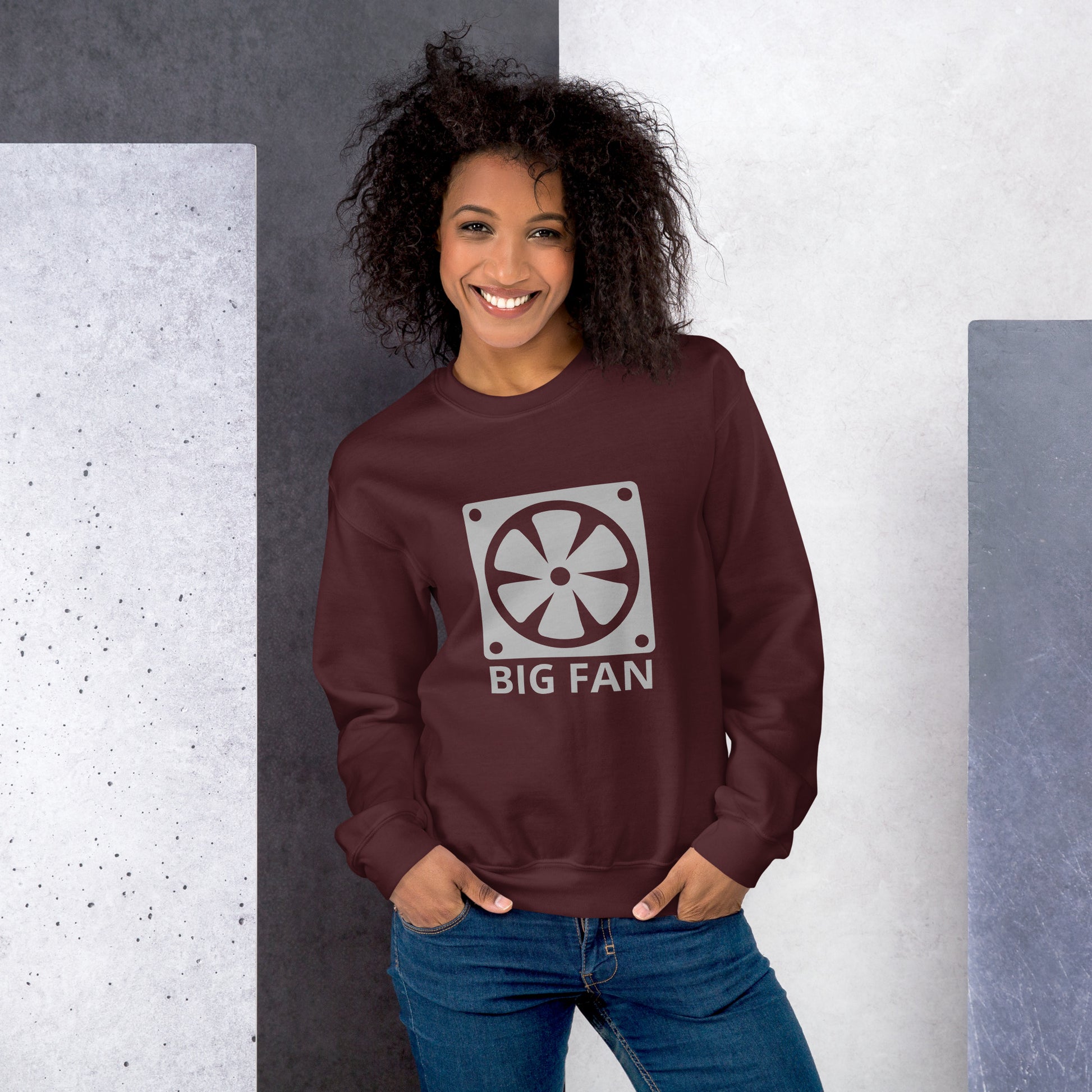 Women with maroon sweatshirt with image of a big computer fan and the text "BIG FAN"
