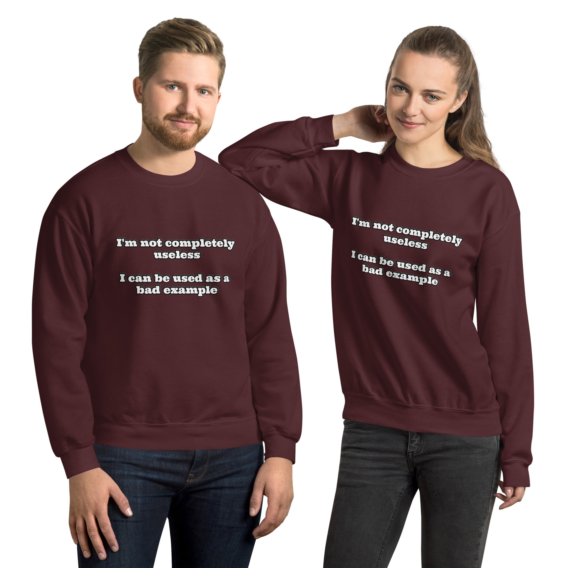 Man and women with maroon sweatshirt with text “I'm not completely useless I can be used as a bad example”