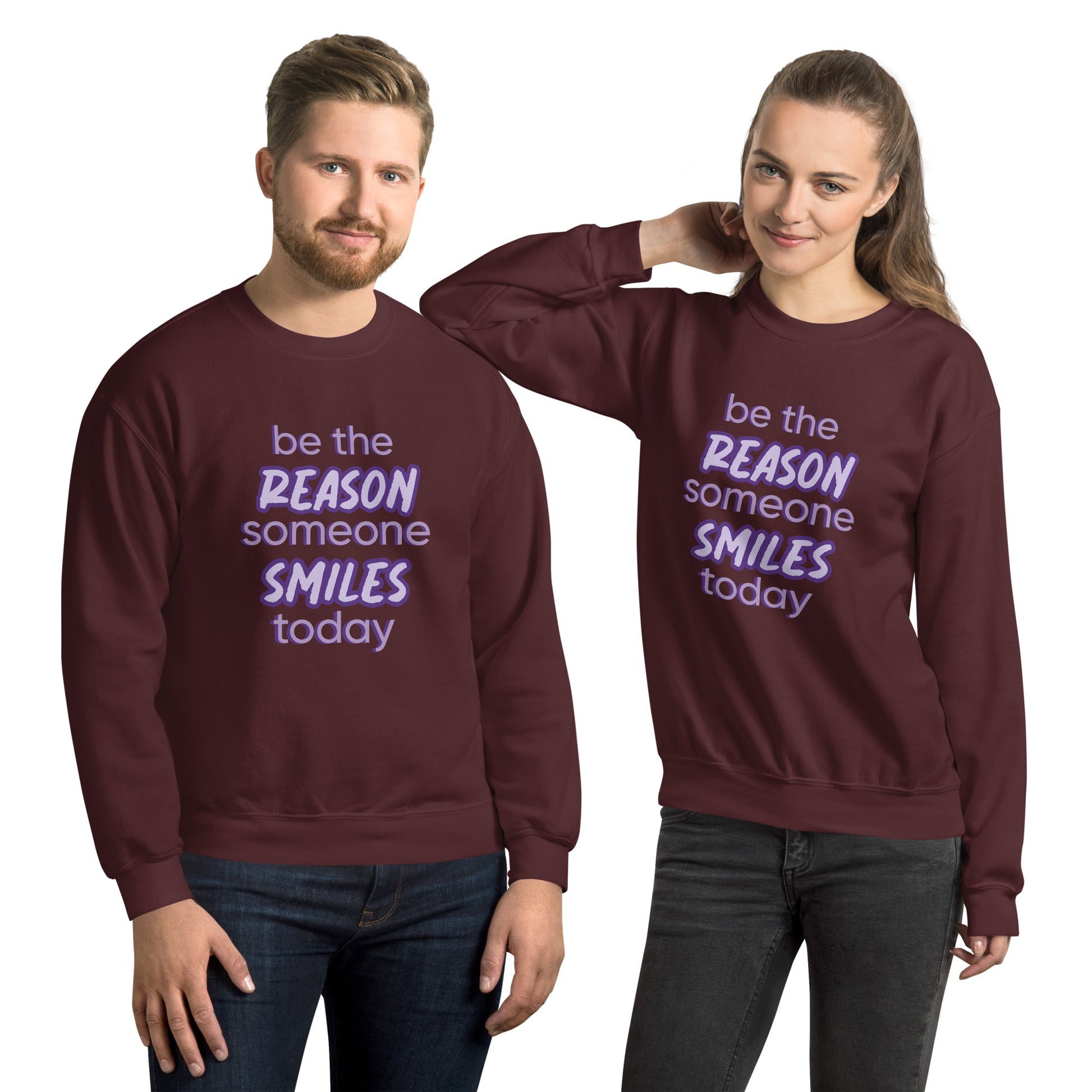 Men and women with maroon sweater and the quote "be the reason someone smiles today" in purple on it. 