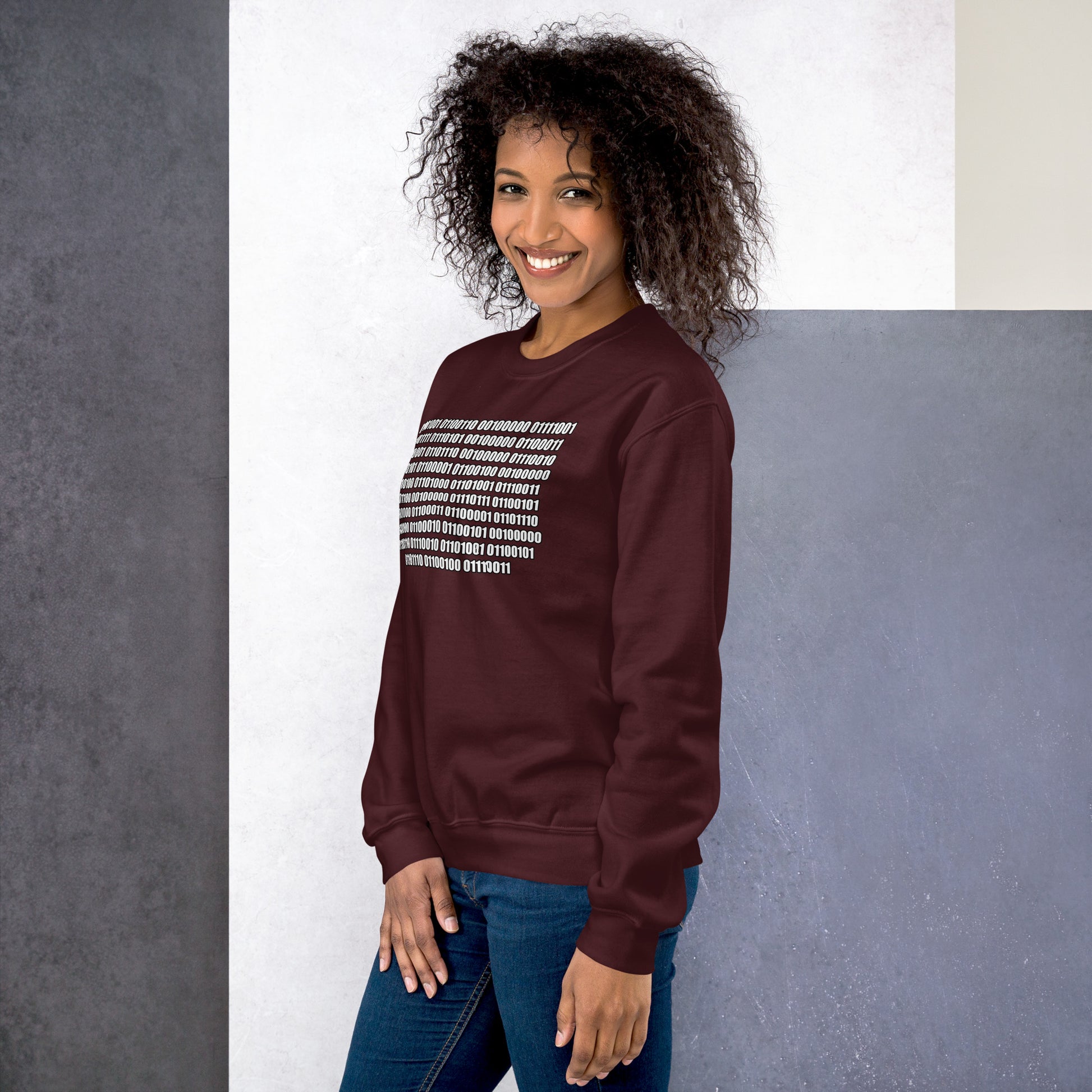 Women with maroon sweatshirt with binaire text "If you can read this"