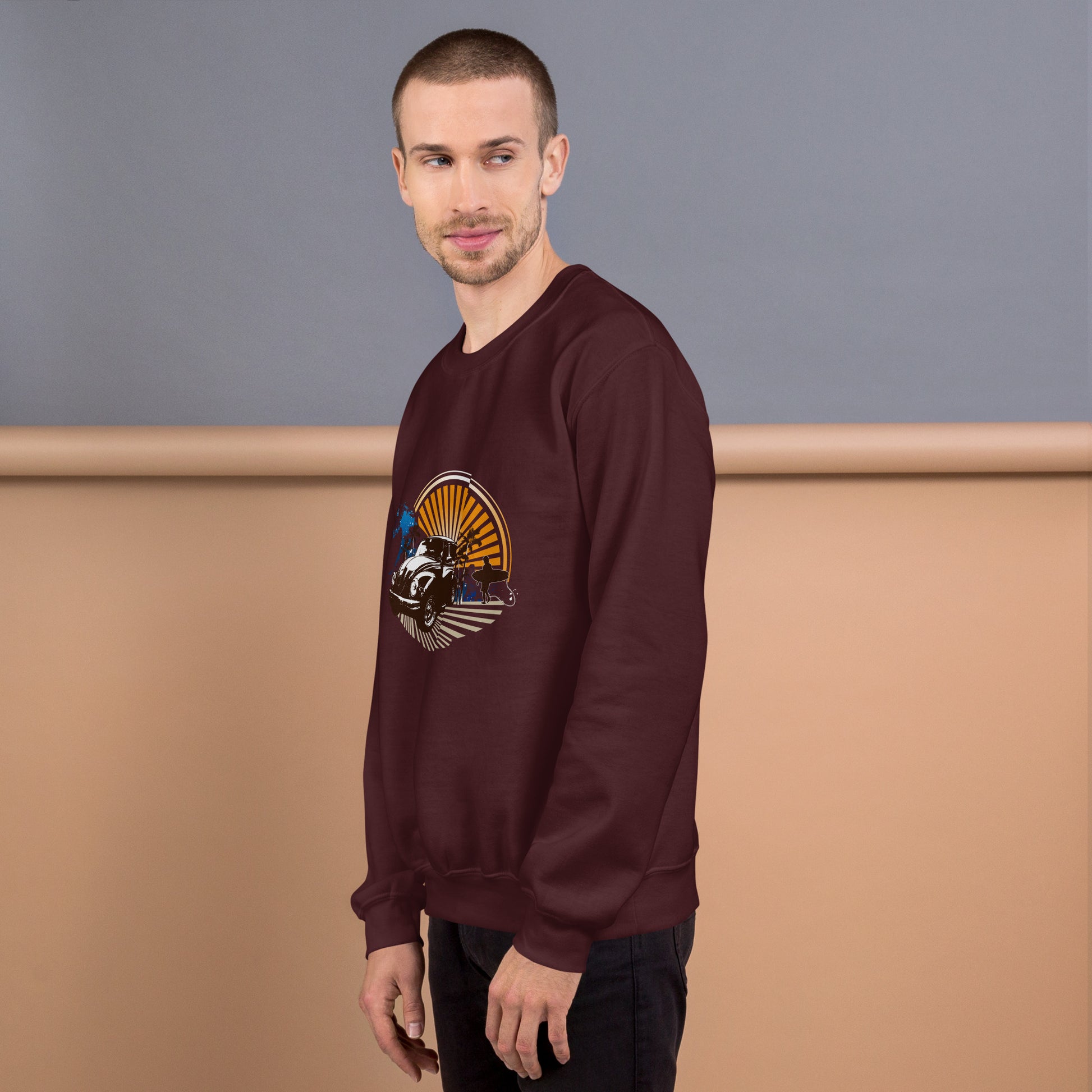 Men with maroon sweatshirt with sunset and beetle car