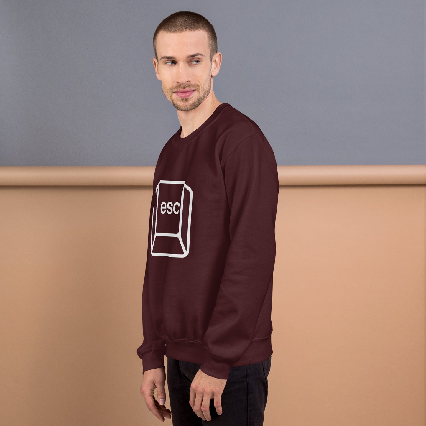 Man with maroon sweatshirt with picture of esc key