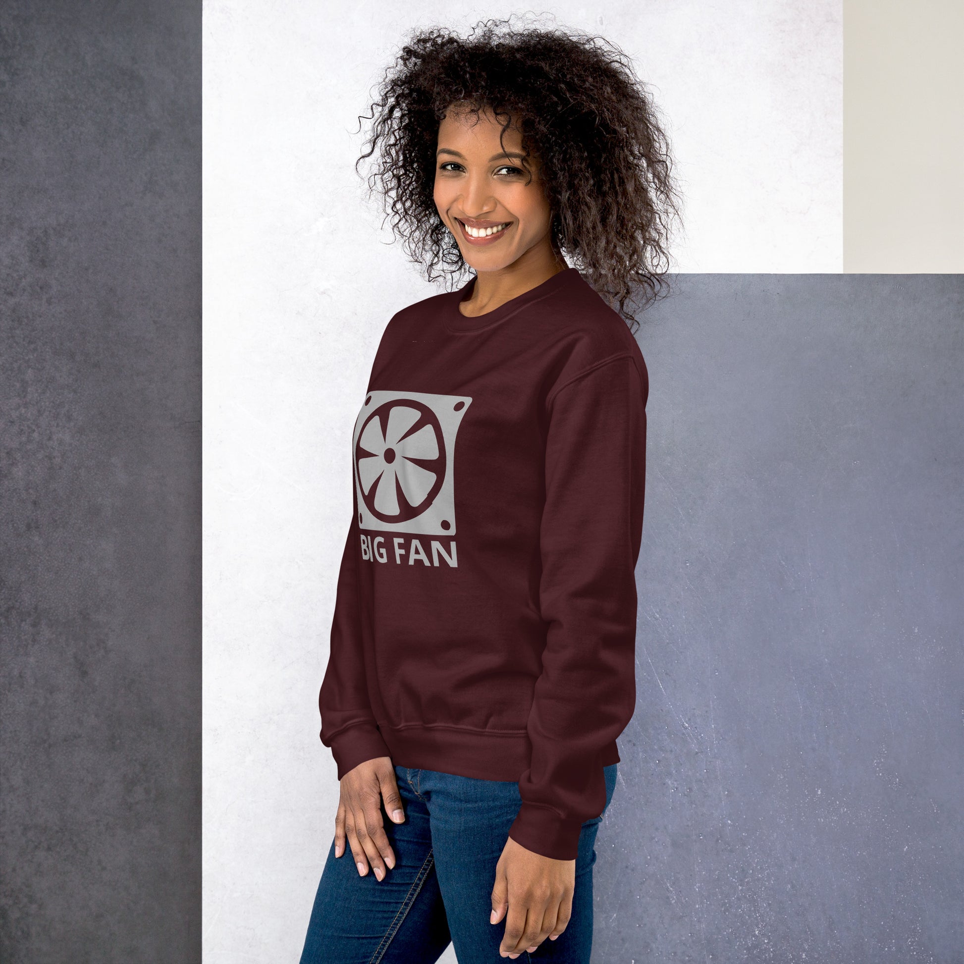 Women with maroon sweatshirt with image of a big computer fan and the text "BIG FAN"