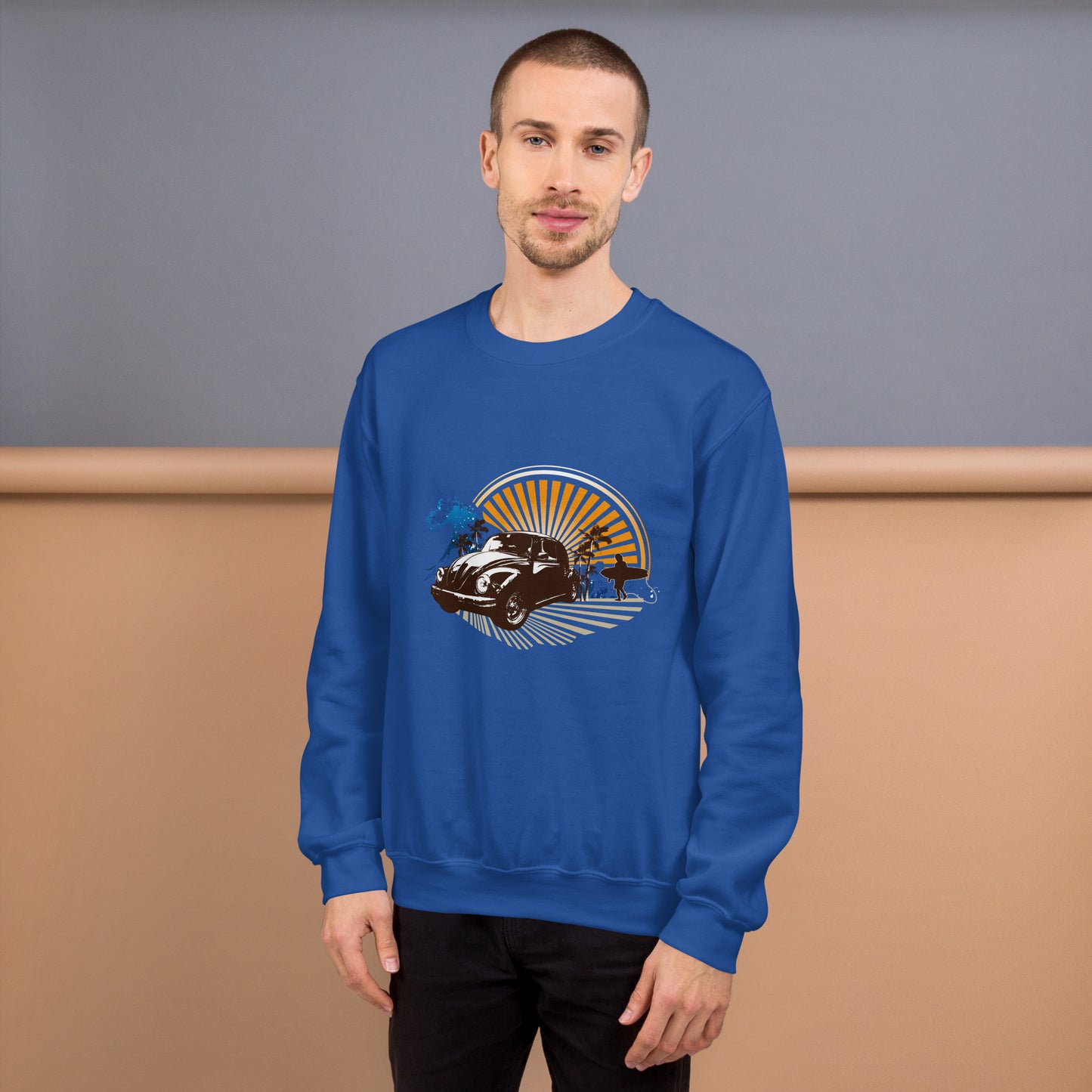 Men with royal blue sweatshirt with sunset and beetle car