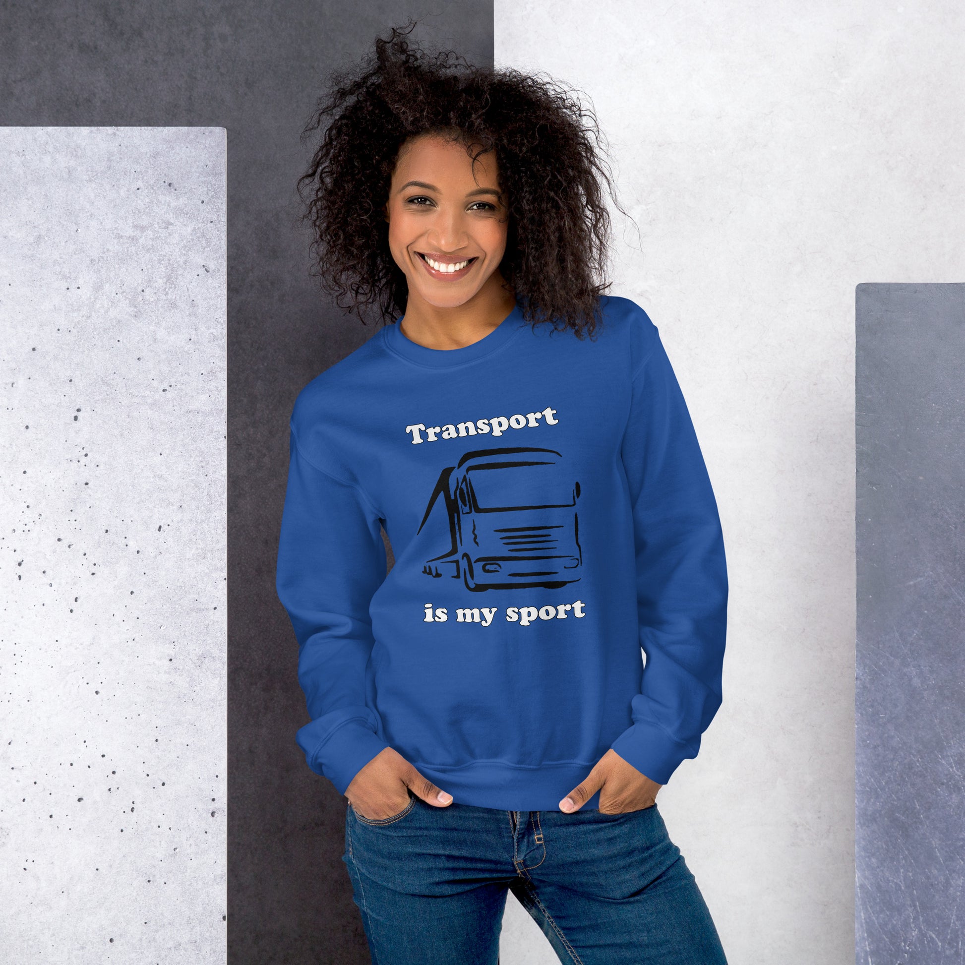 Woman with royal blue sweatshirt with picture of truck and text "Transport is my sport"