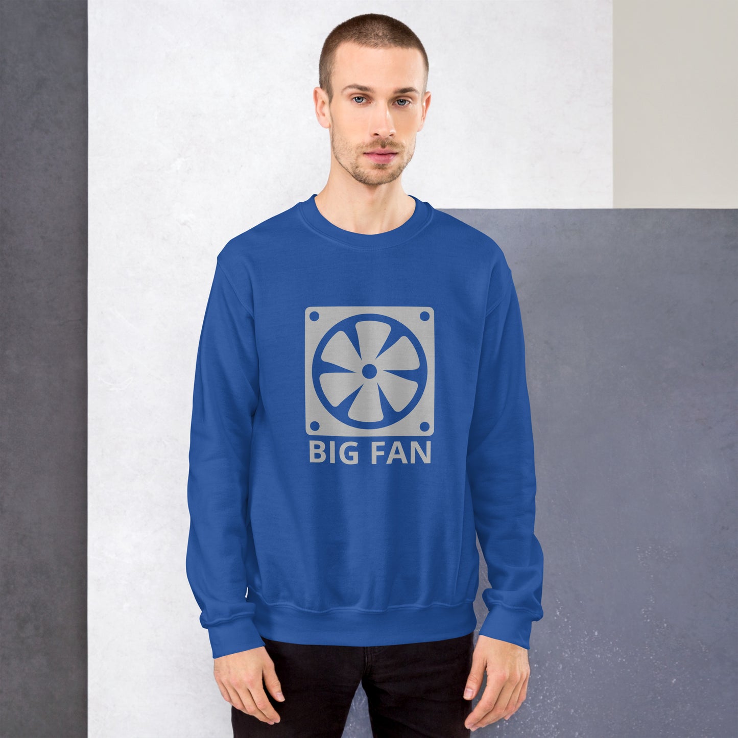 Men with royal blue sweatshirt with image of a big computer fan and the text "BIG FAN"