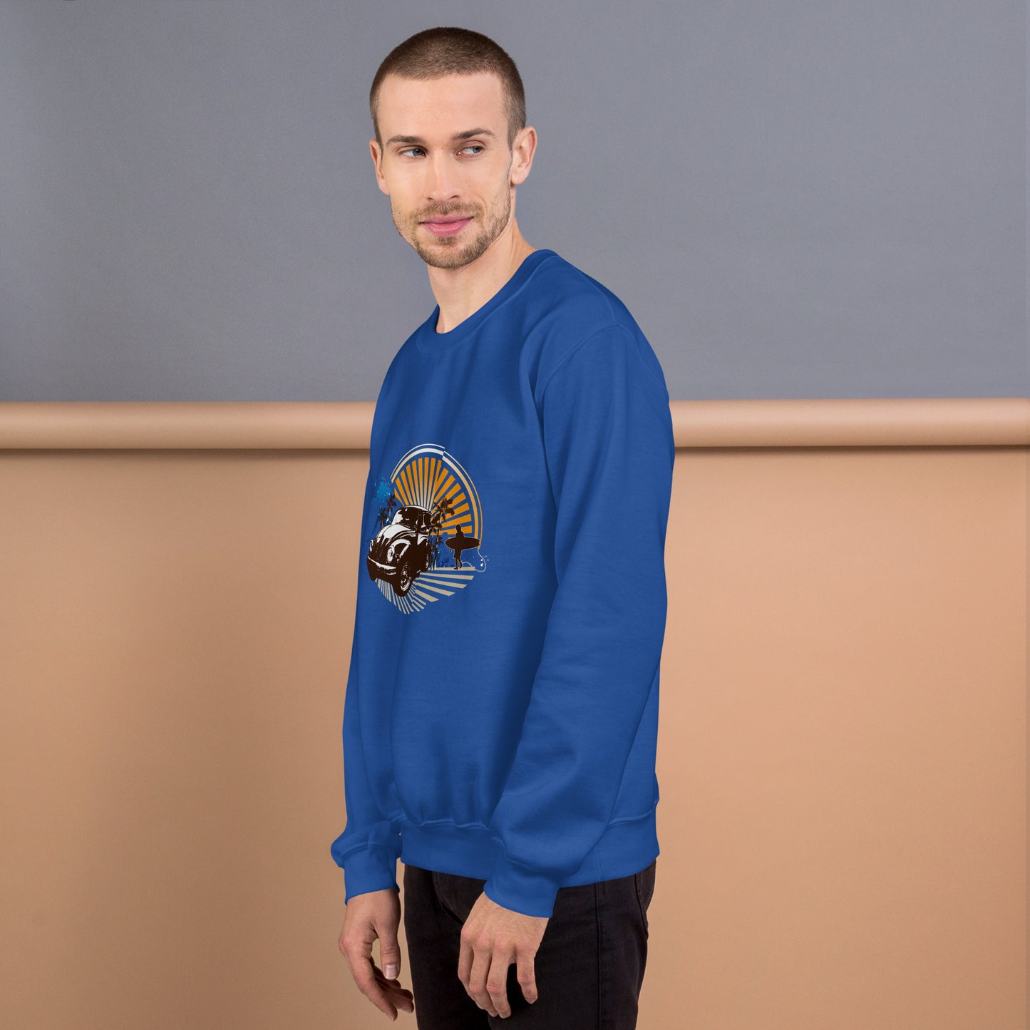Men with royal blue sweatshirt with sunset and beetle car