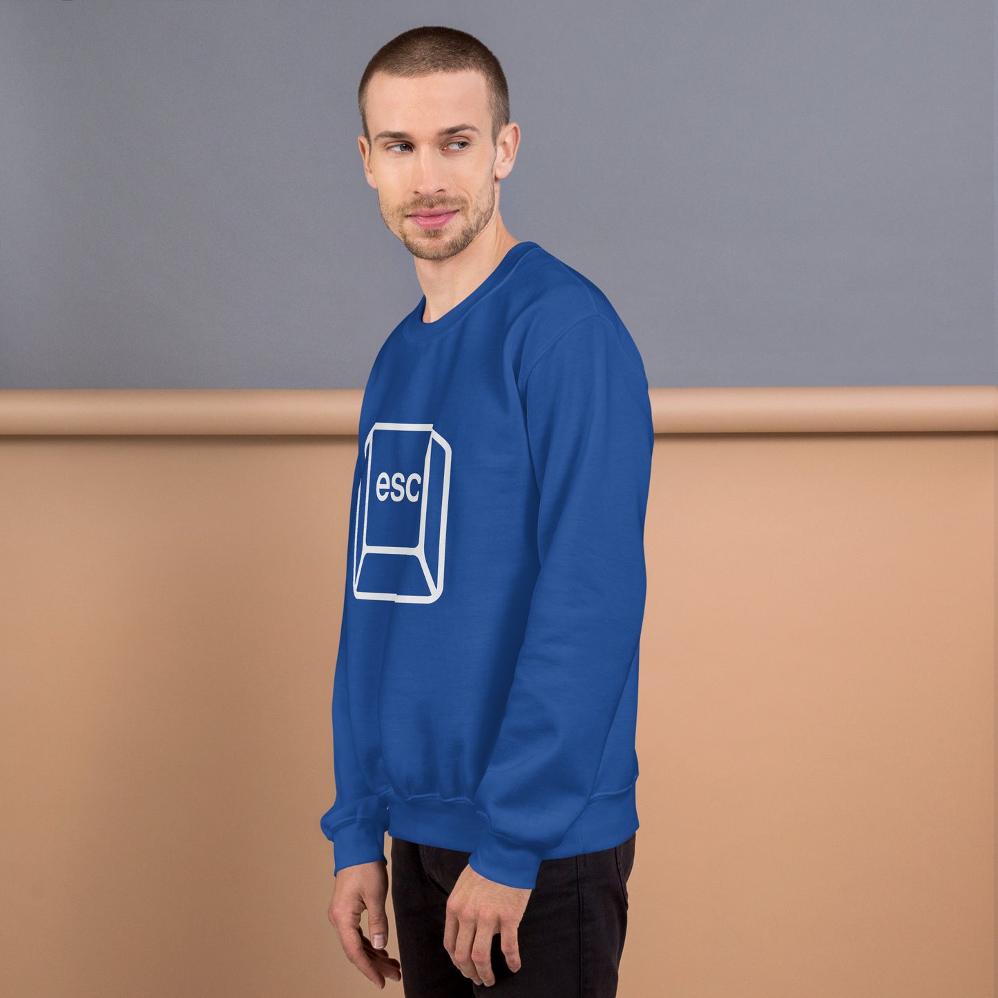 Man with royal blue sweatshirt with picture of esc key