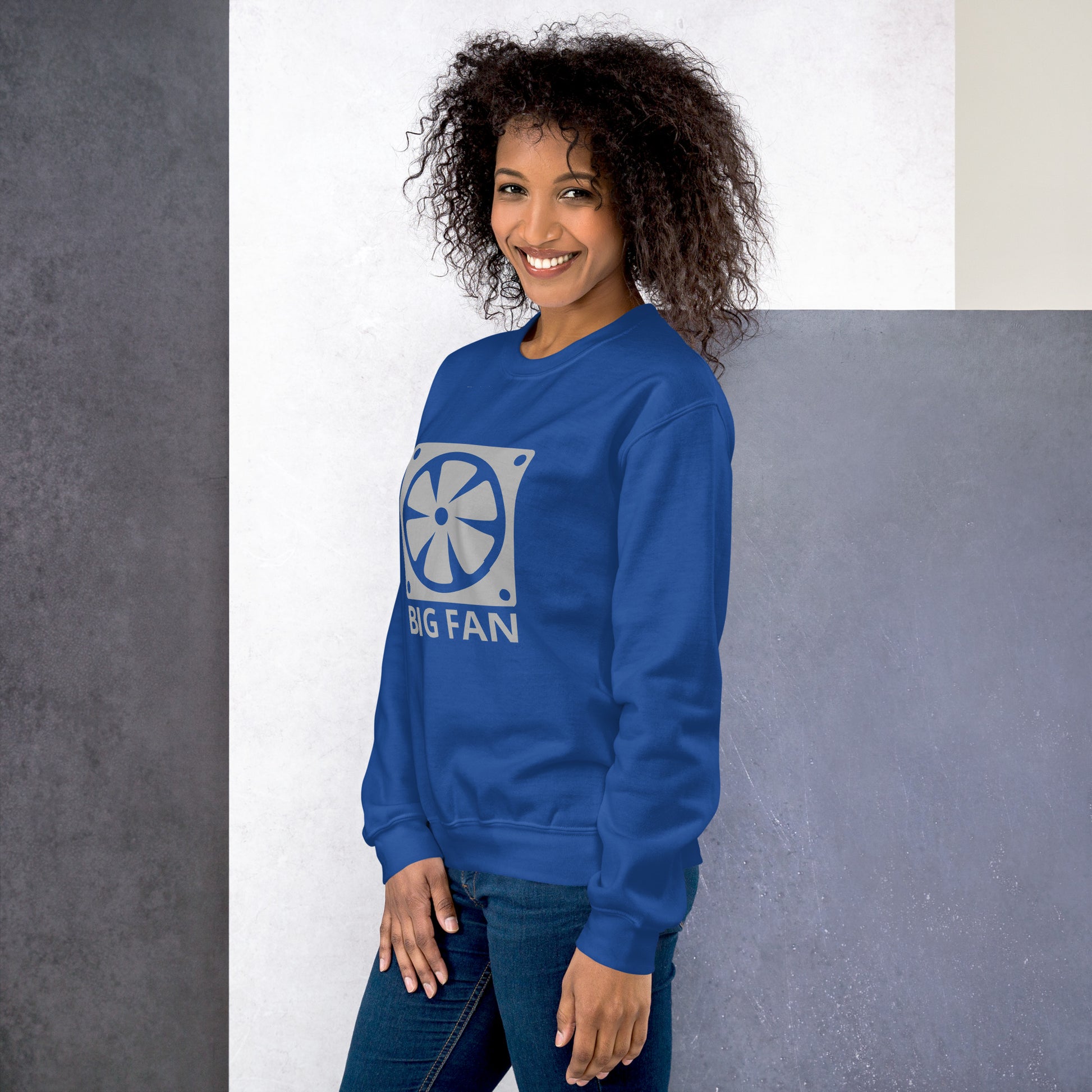 Women with royal blue sweatshirt with image of a big computer fan and the text "BIG FAN"
