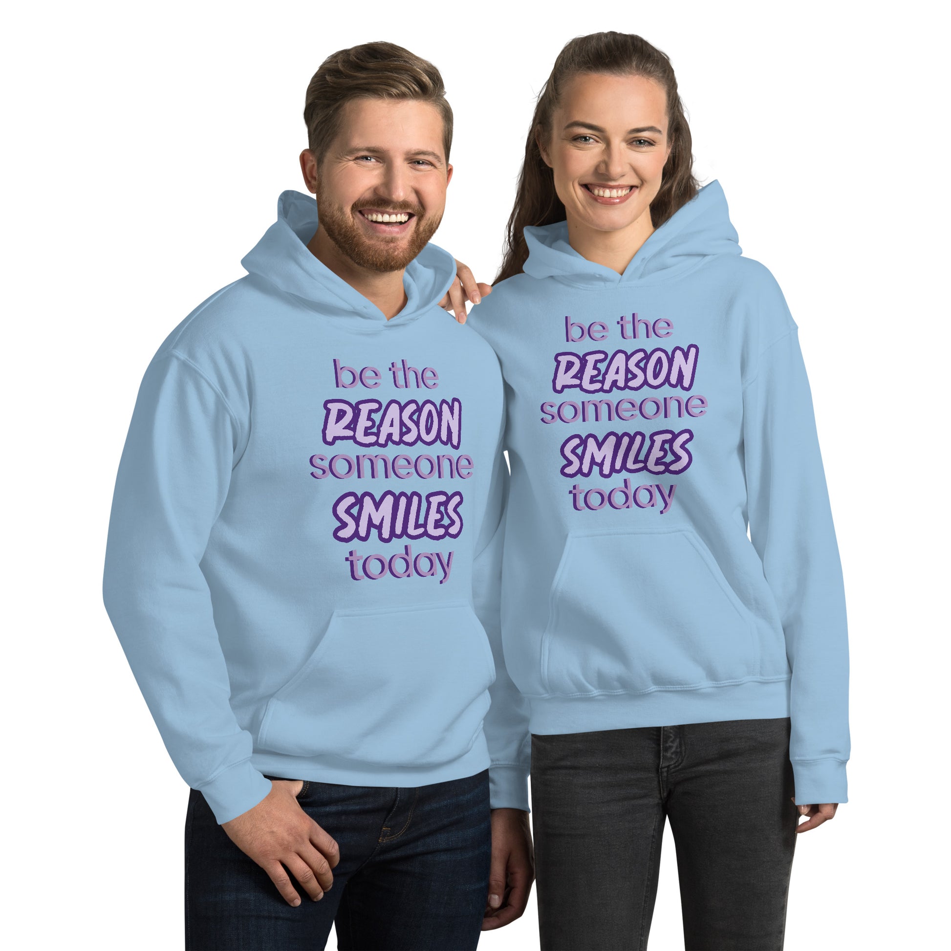 Men and women with light blue hoodie and the quote "be the reason someone smiles today" in purple on it. 