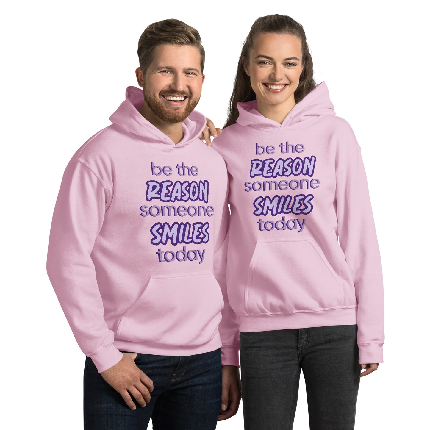 Men and women with light pink hoodie and the quote "be the reason someone smiles today" in purple on it. 
