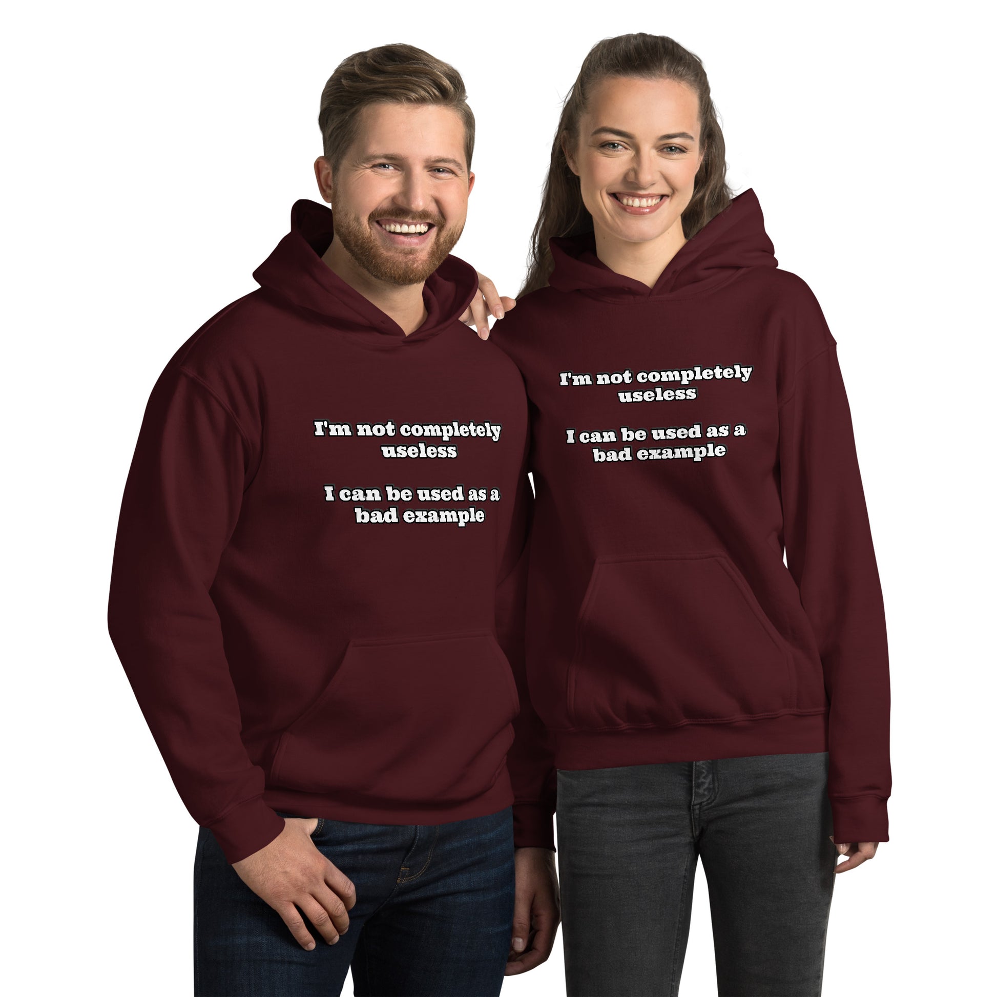 Man and women with maroon hoodie with text “I'm not completely useless I can be used as a bad example”