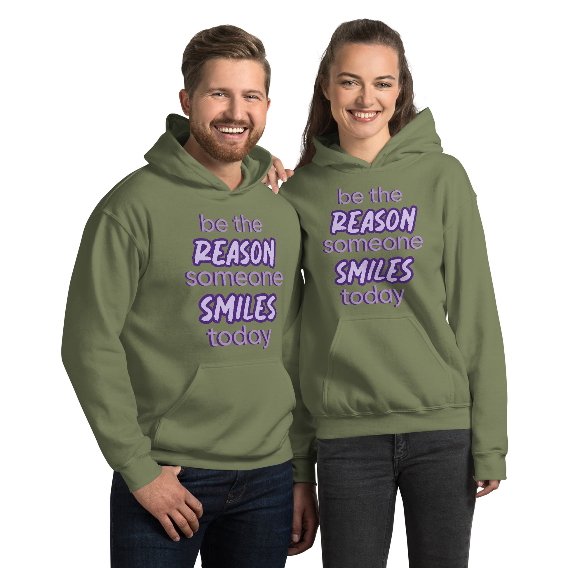 Men and women with Military green hoodie and the quote "be the reason someone smiles today" in purple on it. 