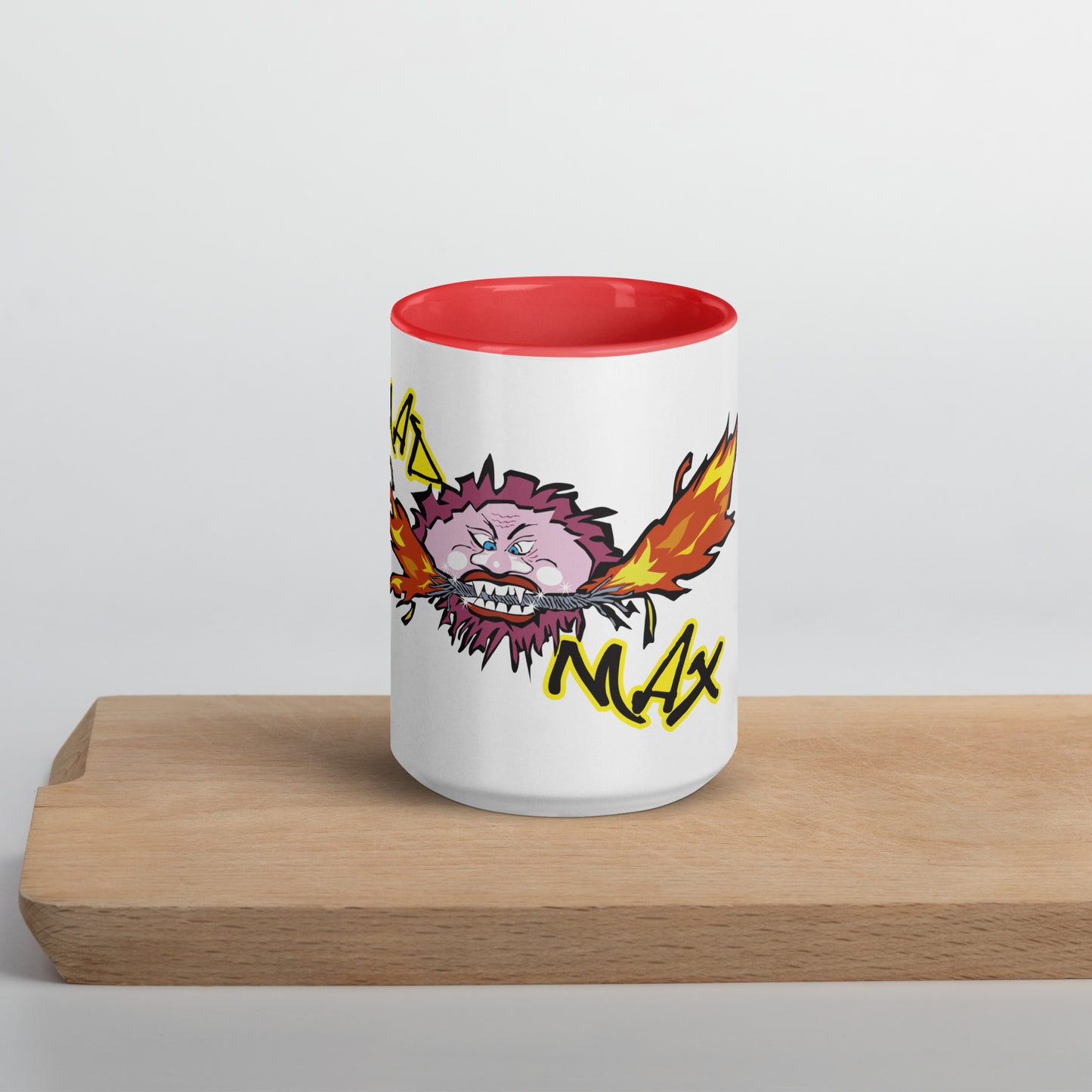 White ceramic mug with mad mad logo and red inside