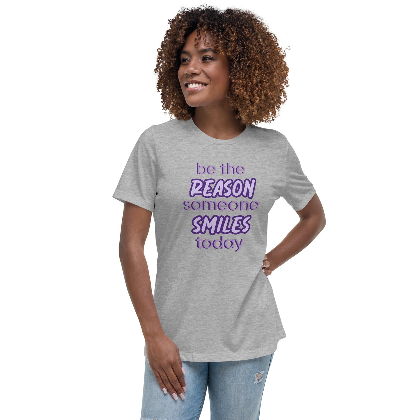 Woman with athletic grey T-shirt and the quote "be the reason someone smiles today" in purple on it.