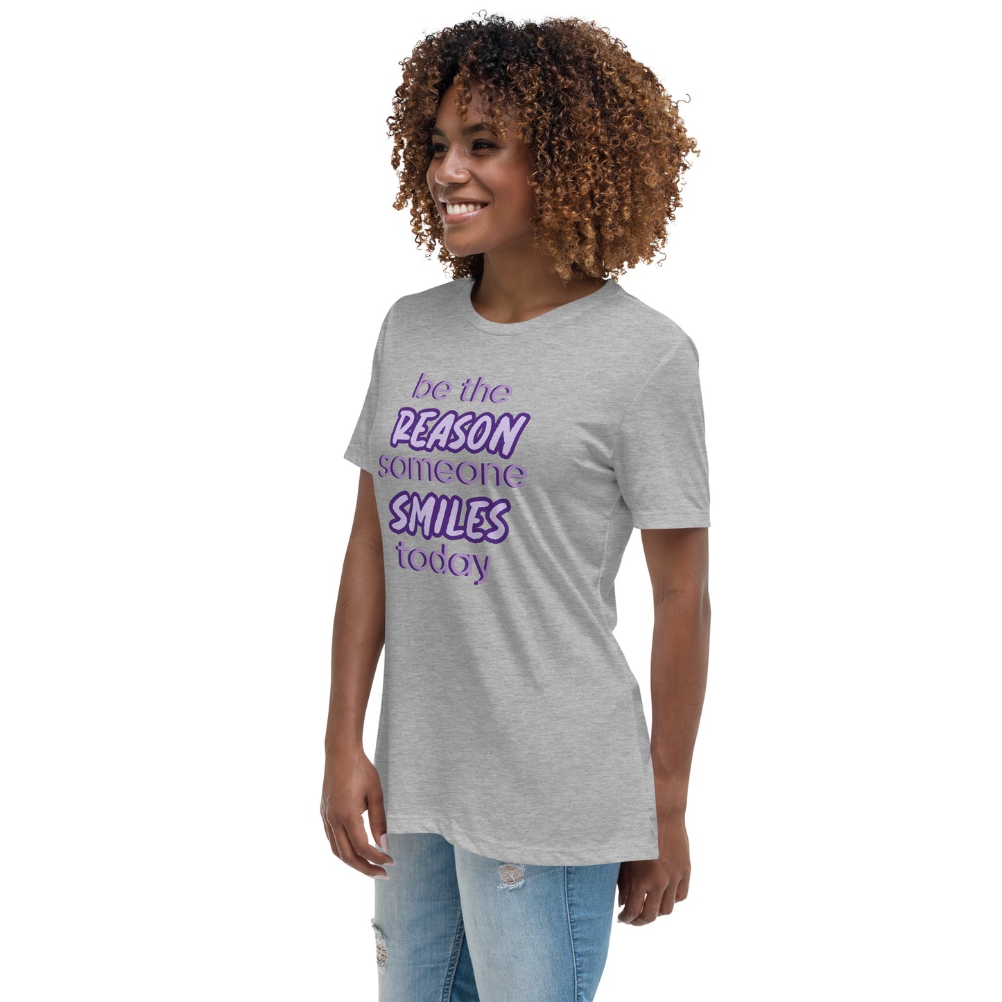 Woman with athletic grey T-shirt and the quote "be the reason someone smiles today" in purple on it.