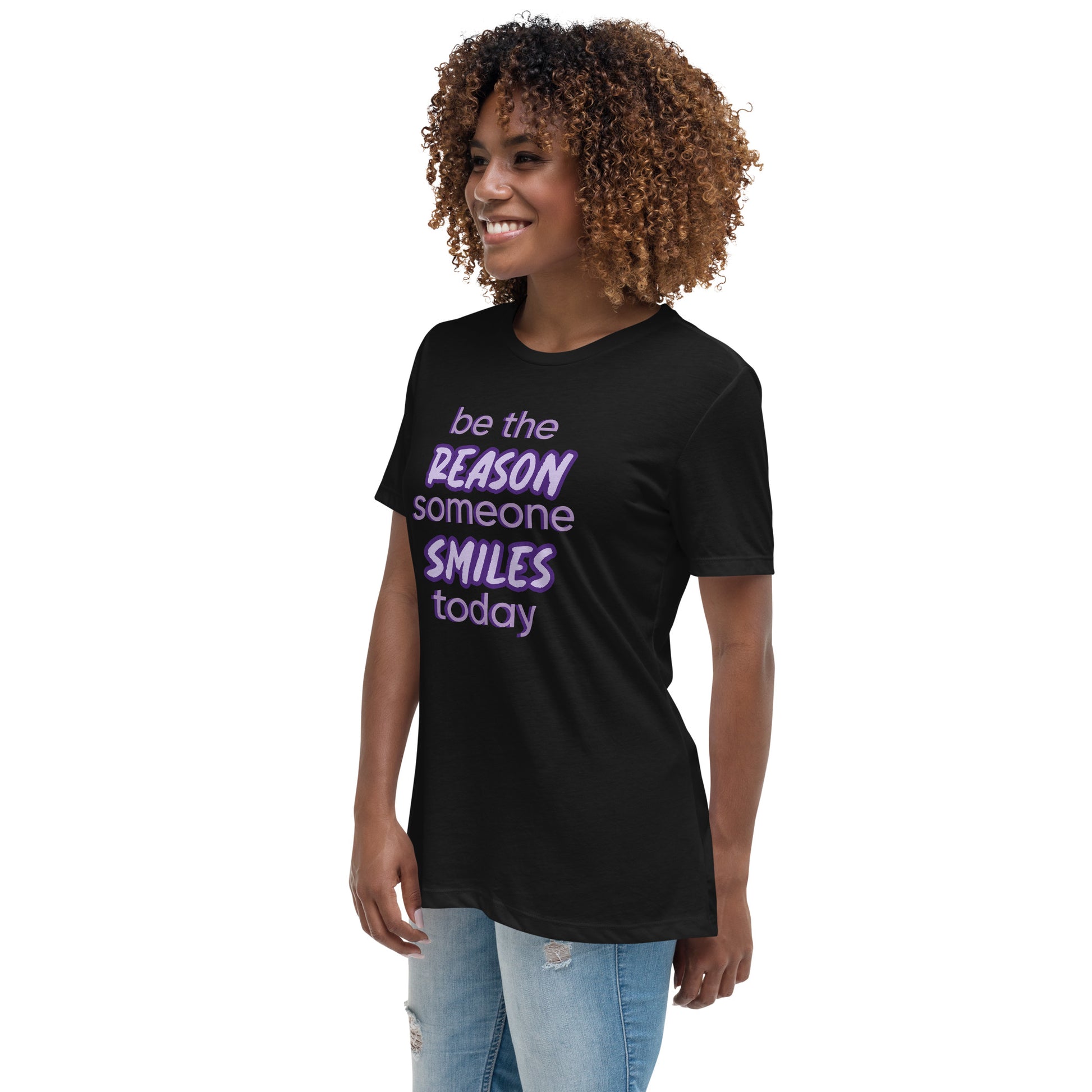 Woman with black T-shirt and the quote "be the reason someone smiles today" in purple on it. 