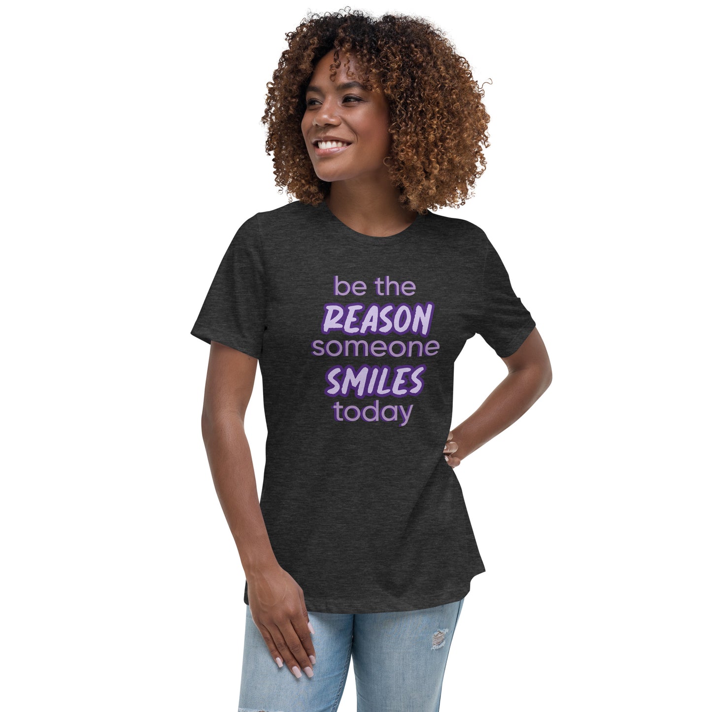 Woman with dark grey T-shirt and the quote "be the reason someone smiles today" in purple on it.