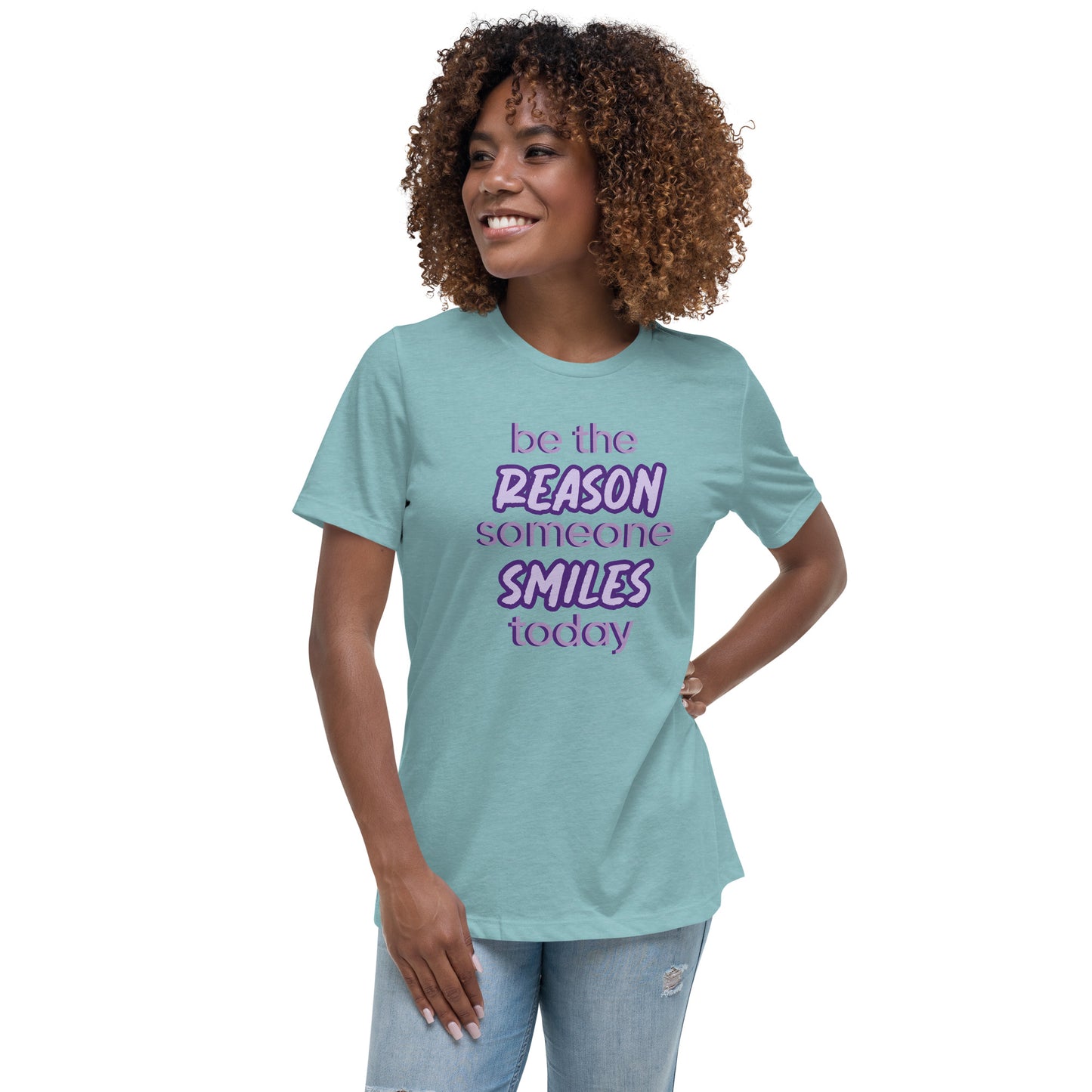 Woman with blue lagoon T-shirt and the quote "be the reason someone smiles today" in purple on it.