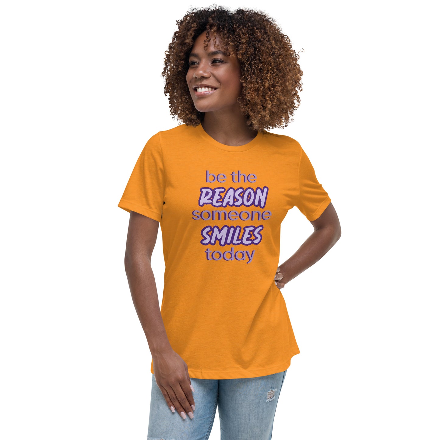 Woman with marmalade T-shirt and the quote "be the reason someone smiles today" in purple on it. 