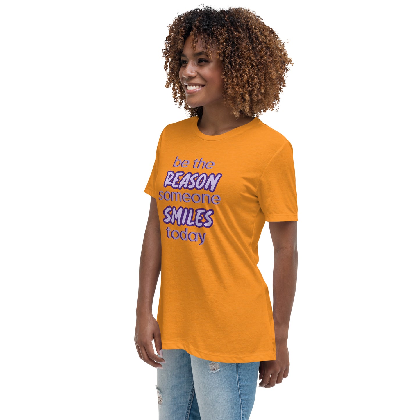 Woman with marmalade T-shirt and the quote "be the reason someone smiles today" in purple on it.