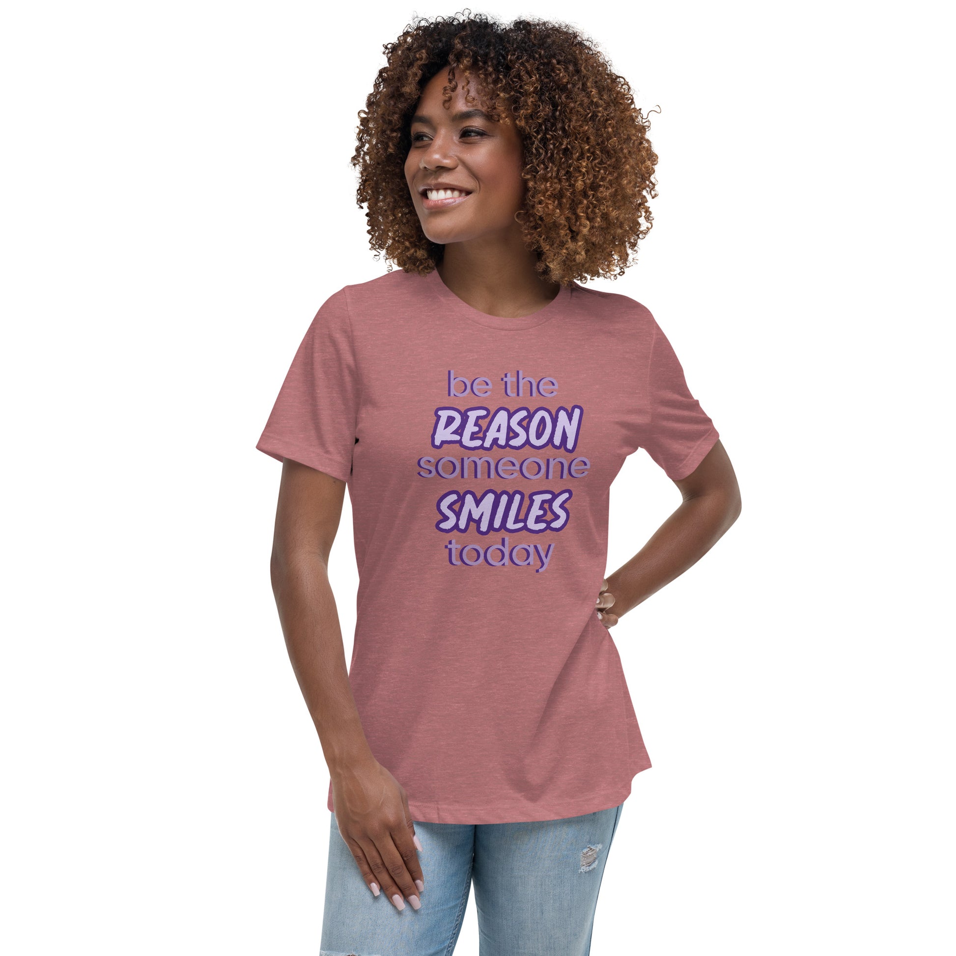 Woman with mauve T-shirt and the quote "be the reason someone smiles today" in purple on it. 
