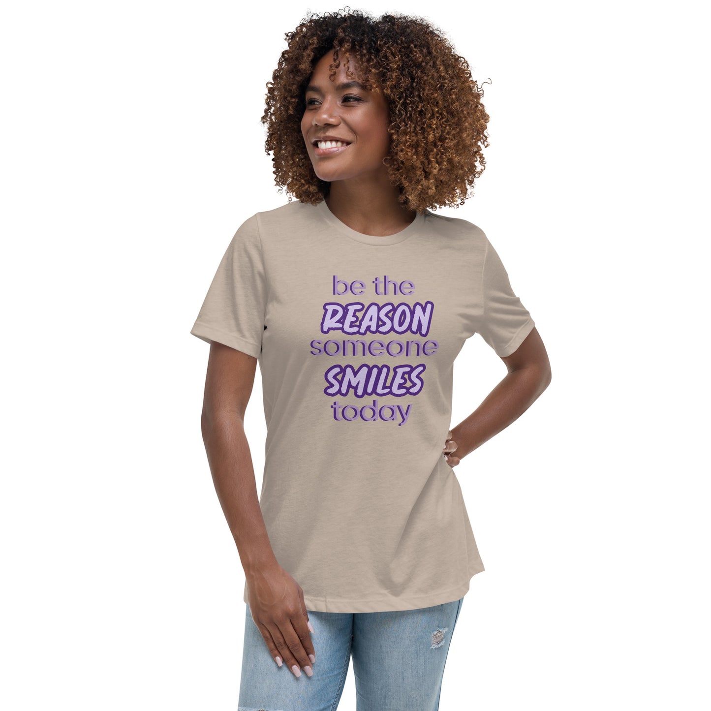 Woman with stone T-shirt and the quote "be the reason someone smiles today" in purple on it.