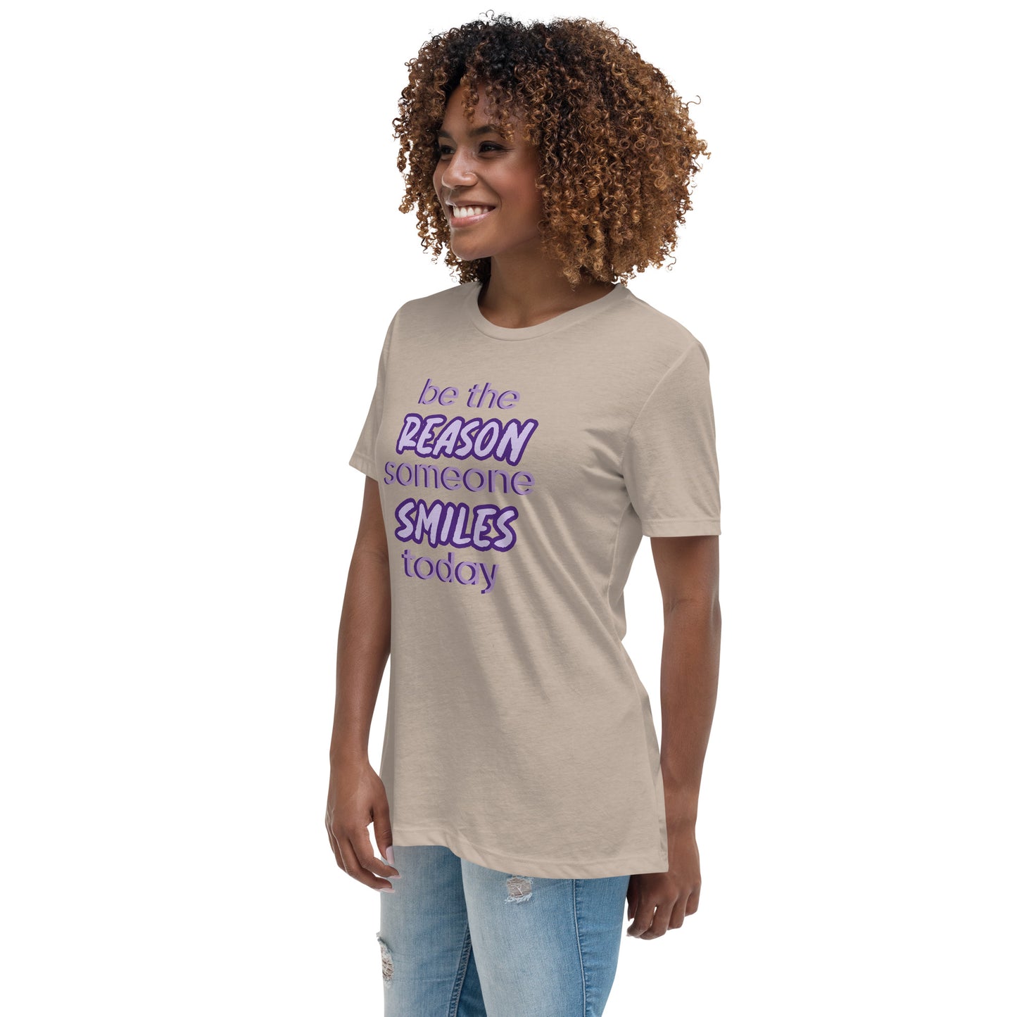 Woman with stone T-shirt and the quote "be the reason someone smiles today" in purple on it.