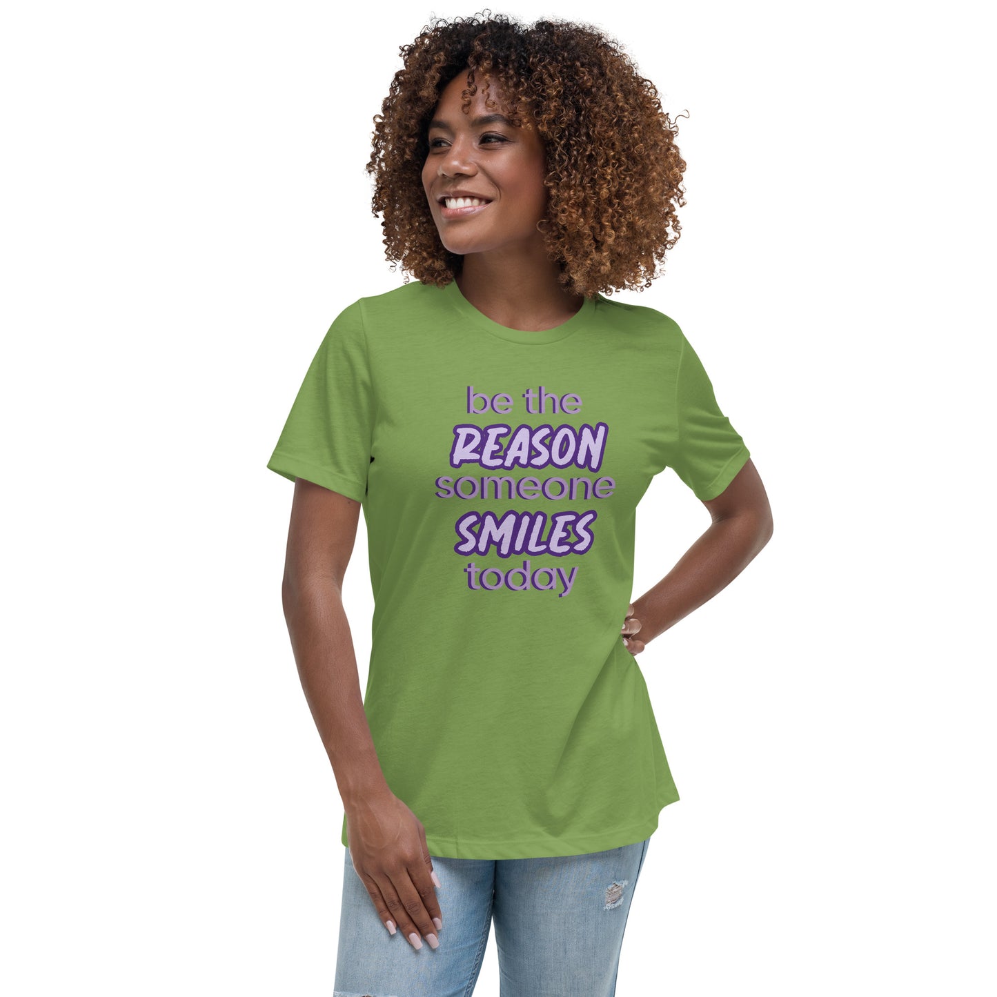 Woman with leaf green T-shirt and the quote "be the reason someone smiles today" in purple on it.