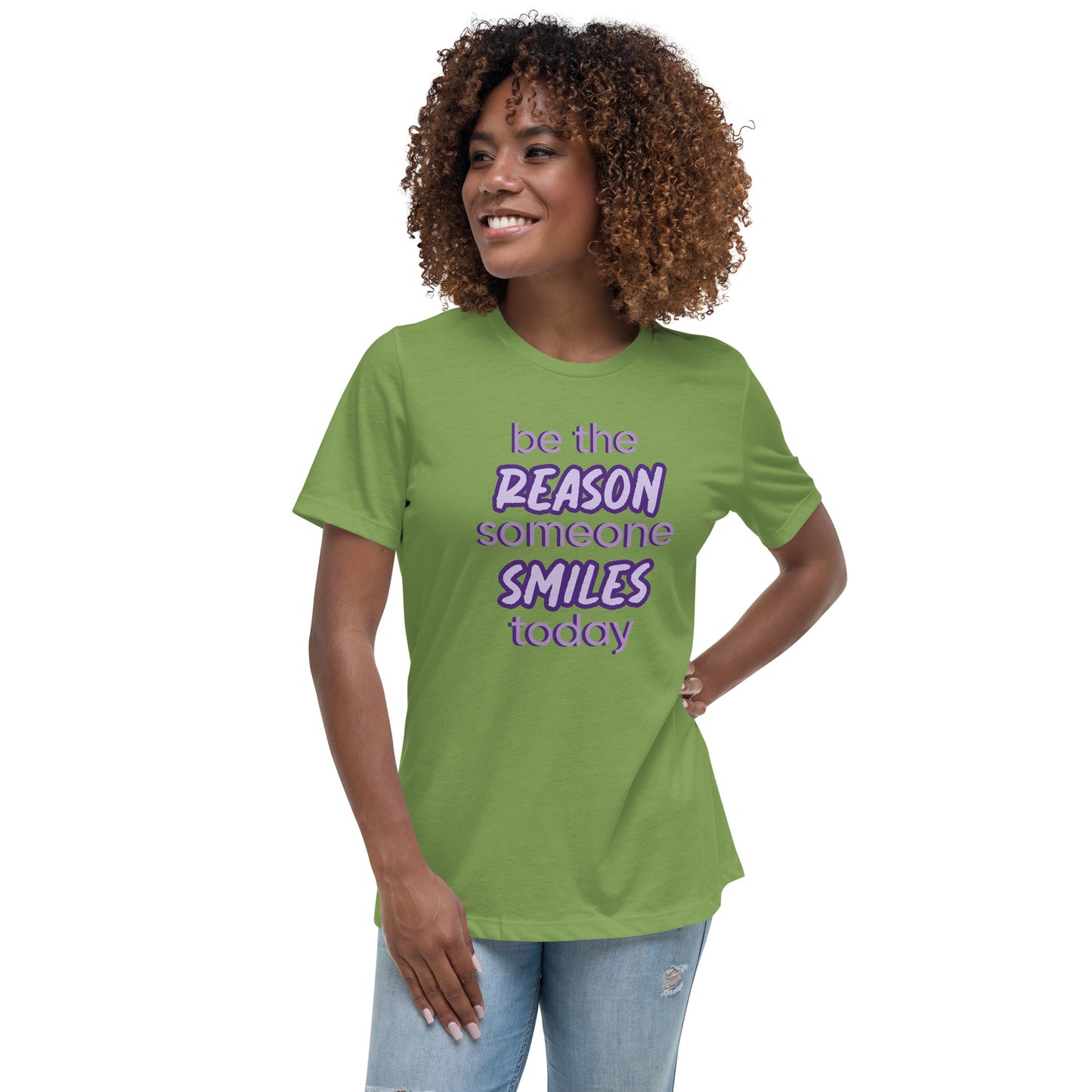 Woman with leaf green T-shirt and the quote "be the reason someone smiles today" in purple on it. 