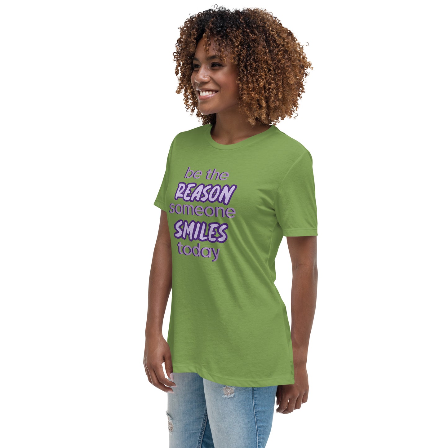 Woman with leaf green T-shirt and the quote "be the reason someone smiles today" in purple on it.