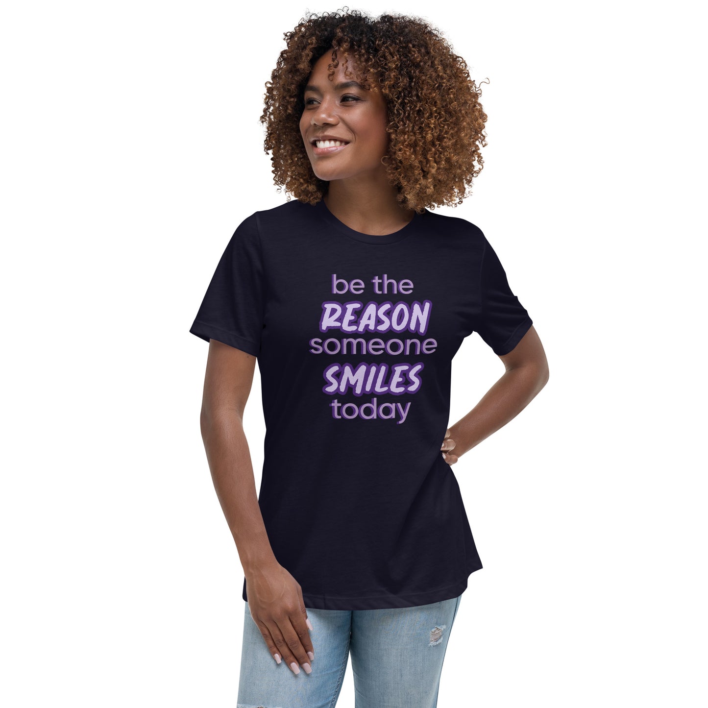 Woman with navy T-shirt and the quote "be the reason someone smiles today" in purple on it.