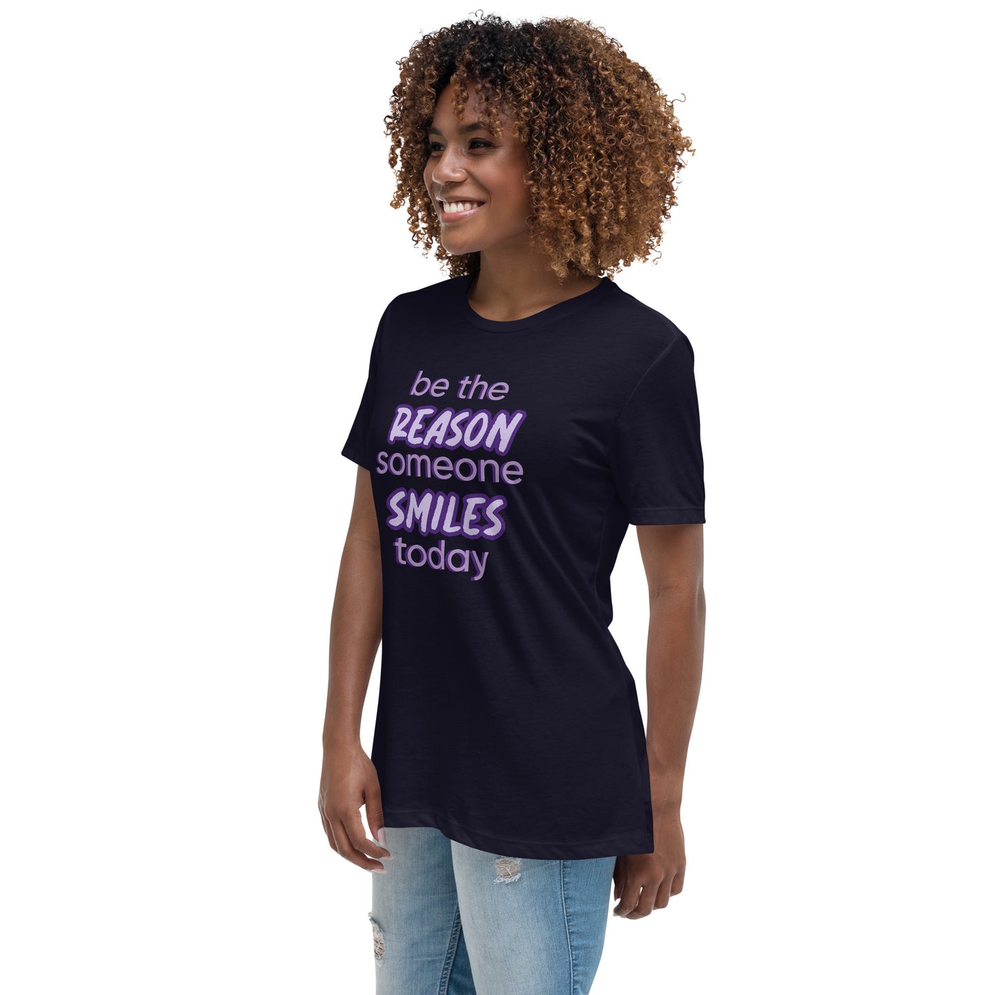 Woman with navy T-shirt and the quote "be the reason someone smiles today" in purple on it.