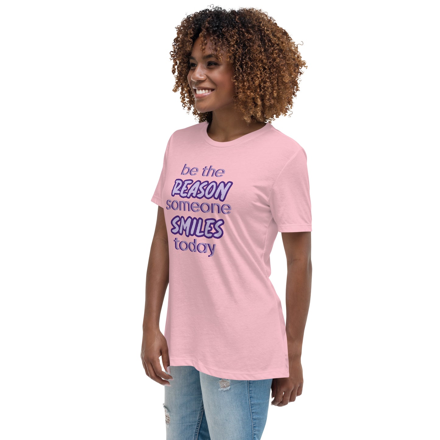 Woman with pink T-shirt and the quote "be the reason someone smiles today" in purple on it.