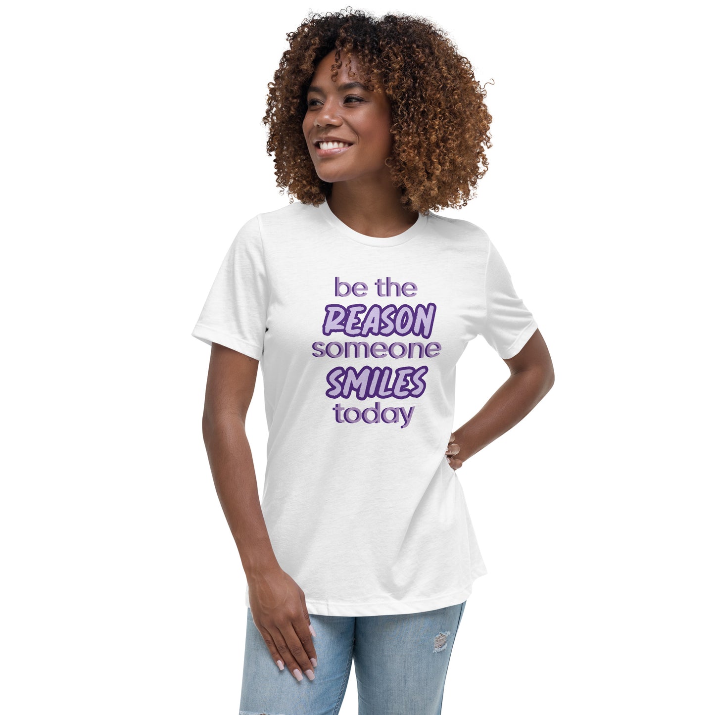 Woman with white T-shirt and the quote "be the reason someone smiles today" in purple on it.