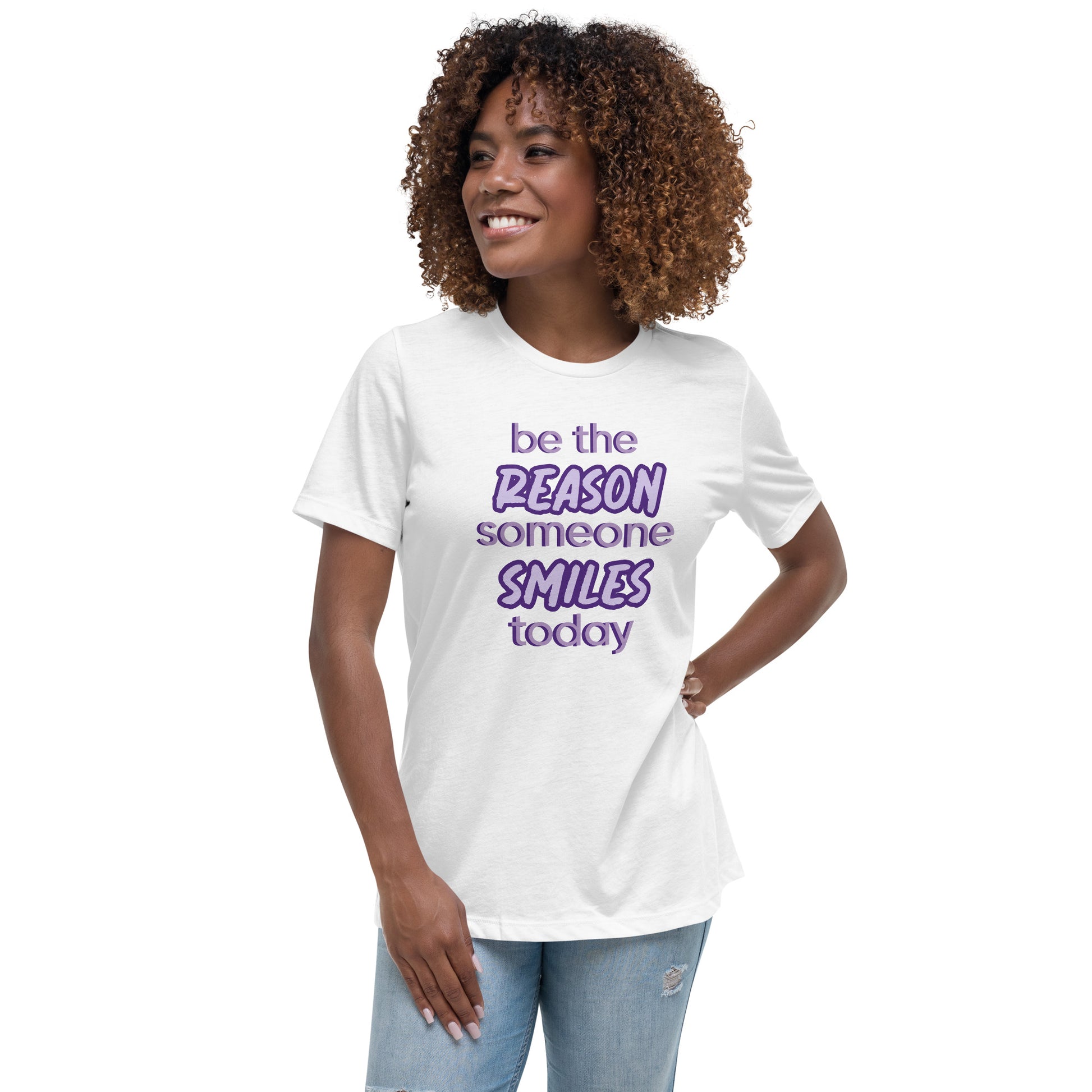 Woman with white T-shirt and the quote "be the reason someone smiles today" in purple on it. 