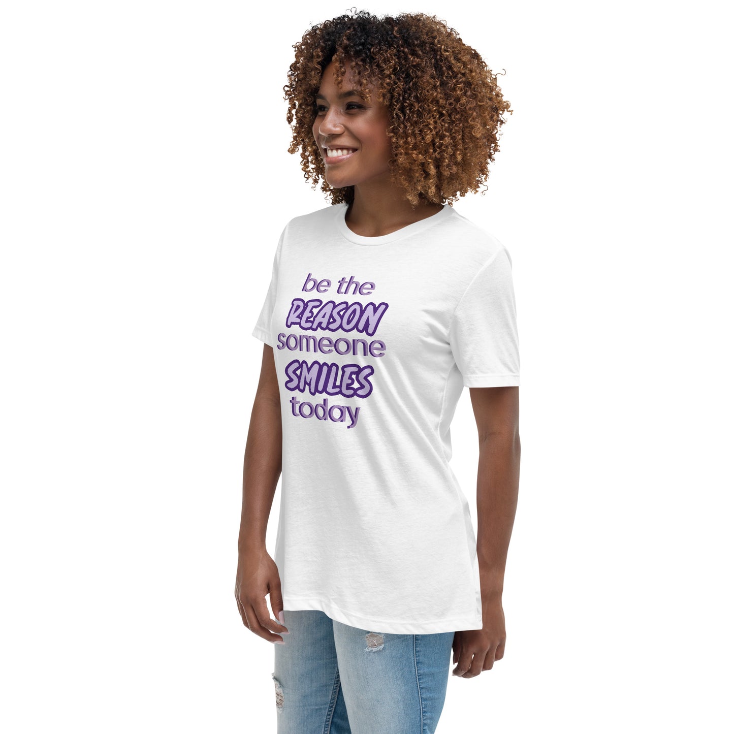 Woman with white T-shirt and the quote "be the reason someone smiles today" in purple on it.